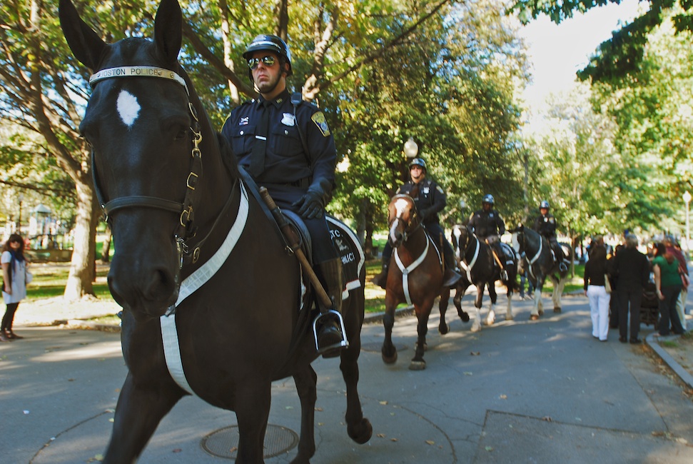  Boston, Mass - Oct. 11, 2008: Police officers mounted on horseback make their way across the Boston Common in anticipation of the anti-war march taking place in downtown Boston. They waited at the entrance of the Common where the march was scheduled