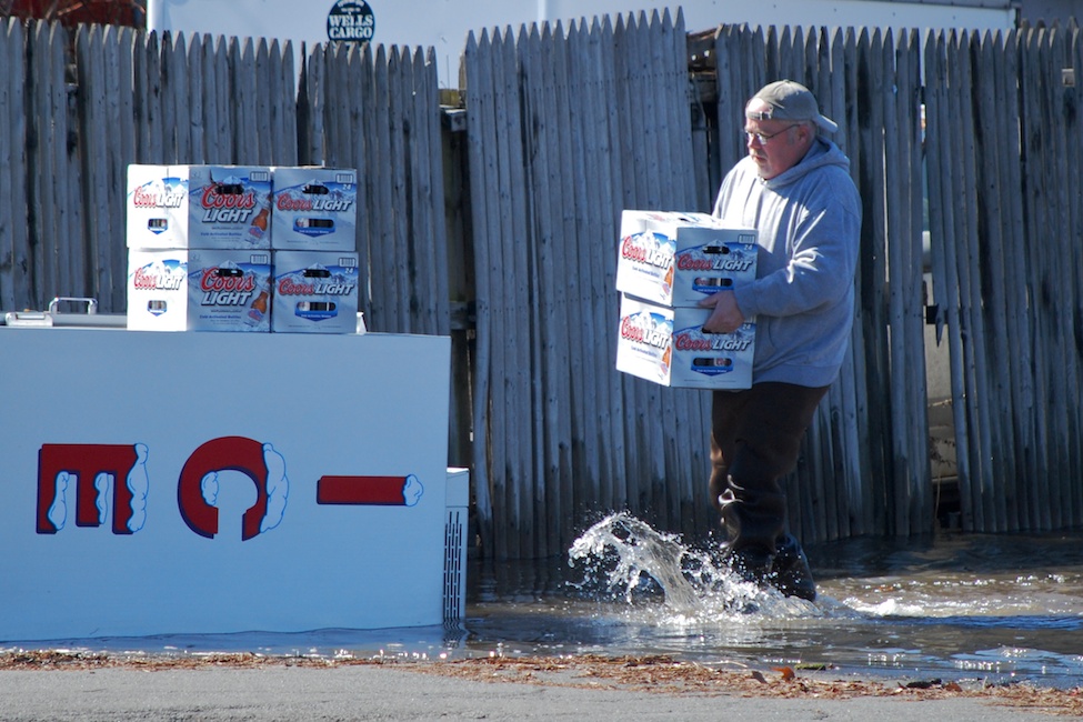  West Nyack, NY - March 7, 2011: A man salvages beers from a liquor store near a flooded highway by The Palisades Mall. Flooded highways caused major traffic problems all over the Tri-State Area.  