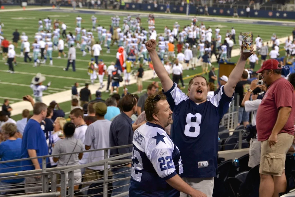 Arlington, Texas - Aug. 11, 2011: Fans celebrate as the Dallas Cowboys win the preseason opener against the Denver Broncos at Cowboys Stadium.