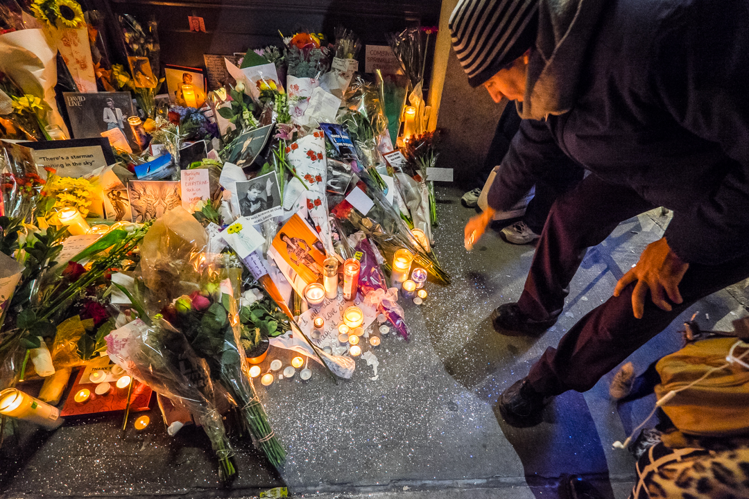  New York, NY - Jan. 11, 2016:  Mourners leave candles, flowers and other tributes outside David Bowie’s apartment at an impromptu vigil following the singer’s death. 