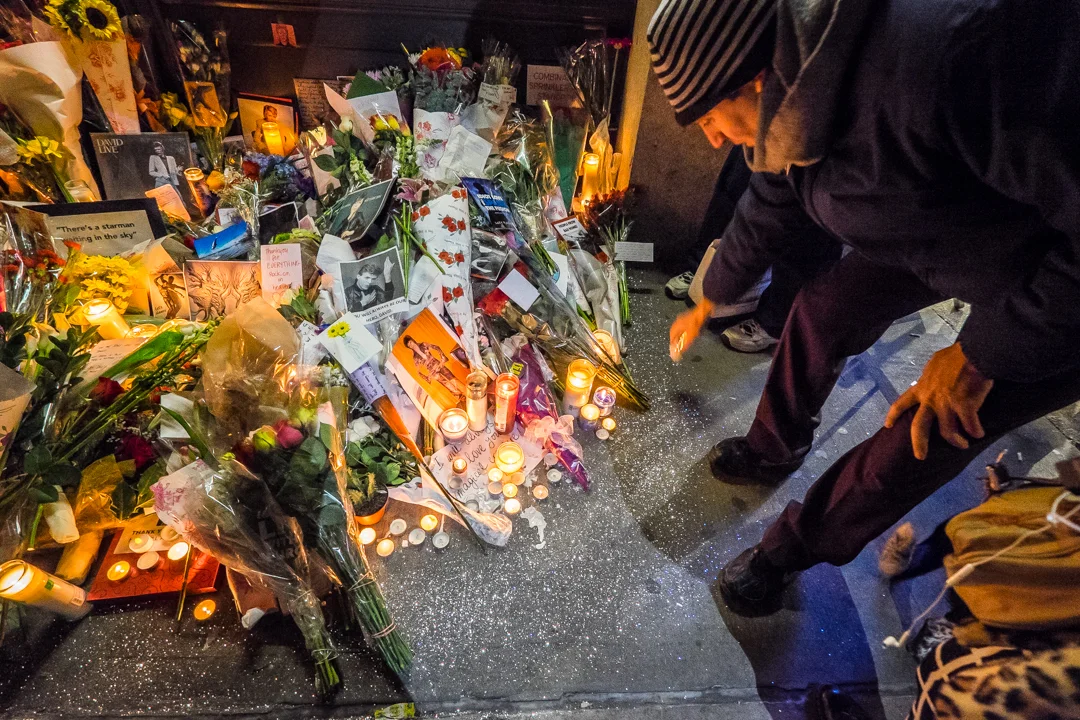 New York, NY - Jan. 11, 2016: Mourners leave candles, flowers and other tributes outside David Bowie’s apartment at an impromptu vigil following the singer’s death.