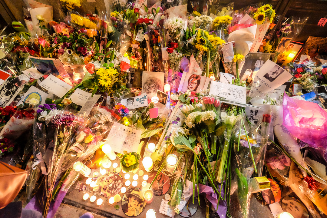  New York, NY - Jan. 11, 2016: Mourners leave candles, flowers and other tributes outside David Bowie’s apartment at an impromptu vigil following the singer’s death. 