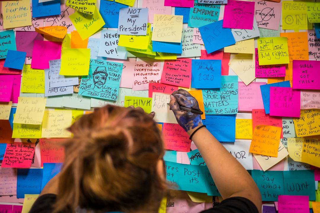  New York, NY - Nov. 16, 2016:  Subway riders cover a wall in the Union Square subway station with post-its in response to the Presidential election of Donald Trump.   