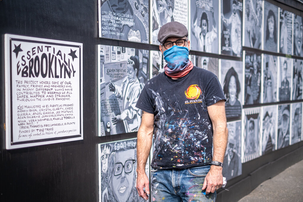  Brooklyn, NY - May 16, 2020:  Artist Joe Patunis poses next to a mural entitled “Essential Brooklyn,” a collaboration by multiple painters featuring portraits of “our family, friends and neighbors who, in many different ways have contributed to keep