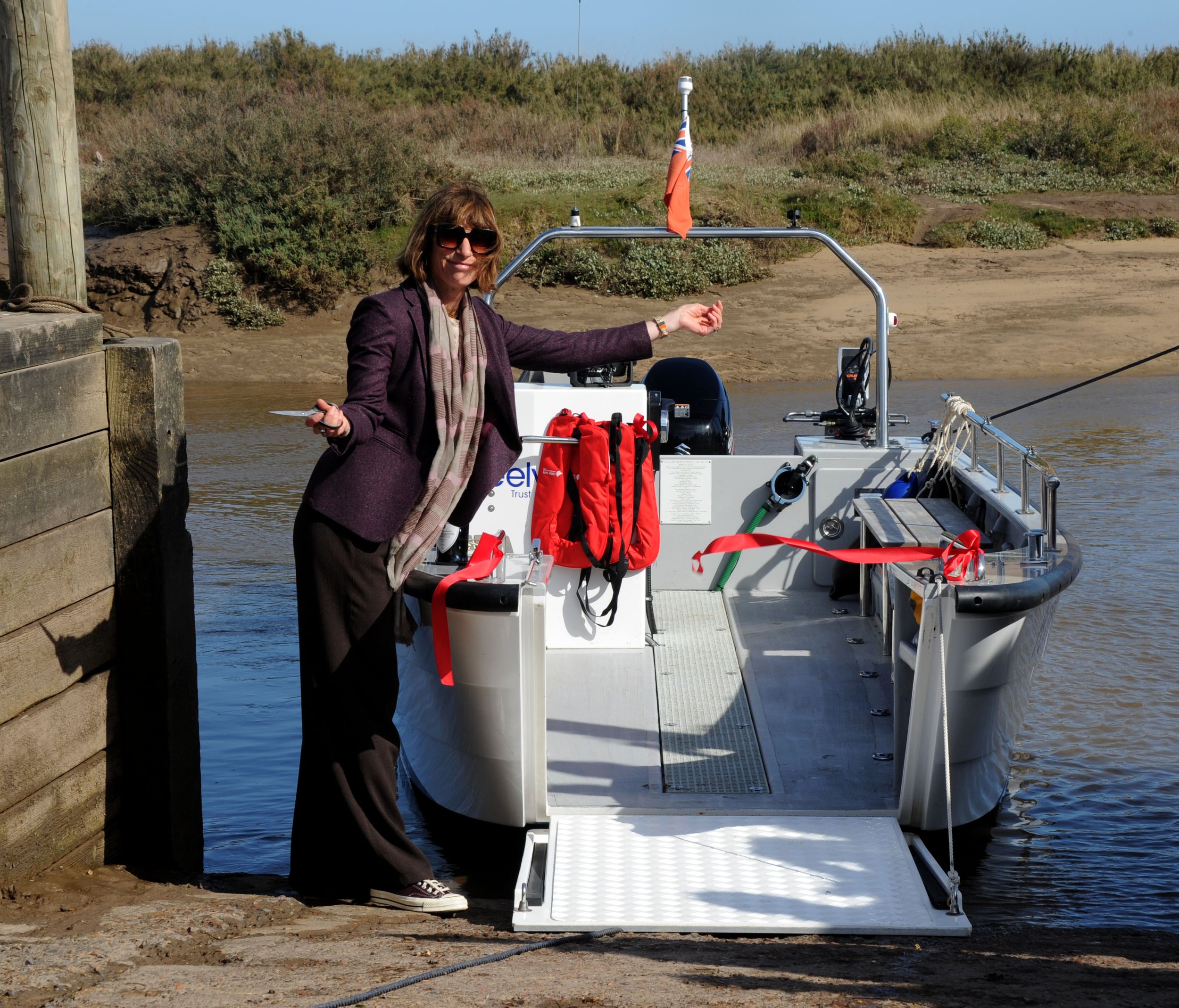 The Countess of Leicester, Polly Coke, cutting the ceremonial ribbon of Poppy, the Coulam V20 Wheelyboat in Blakeney Harbour, north Norfolk (2). Credit Alban Donohoe.JPG