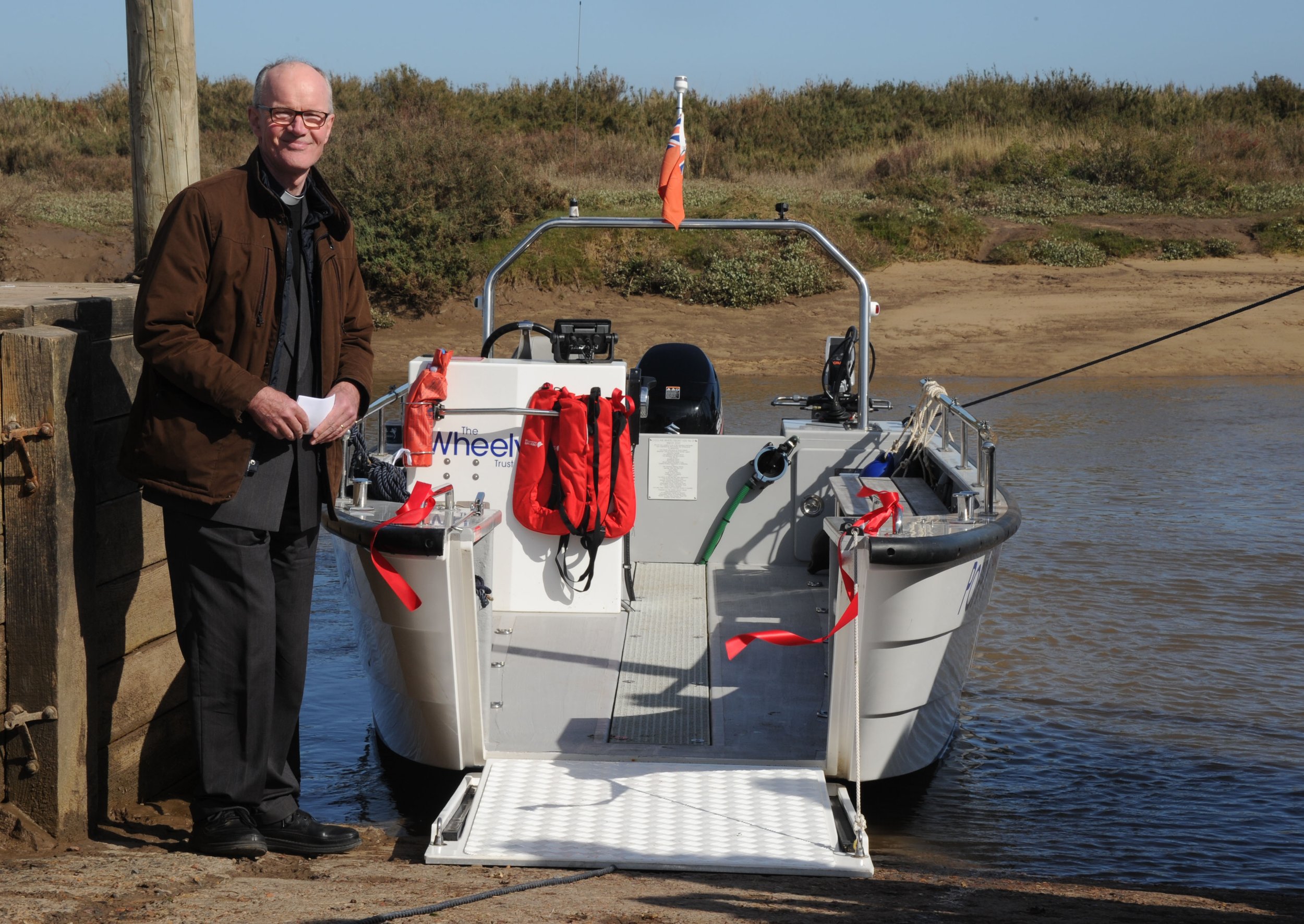Reverend Richard Lawry with 'Poppy', the new Coulam V20 Wheelyboat in Blakeney Harbour, north Norfolk. Credit Alban Donoho.JPG