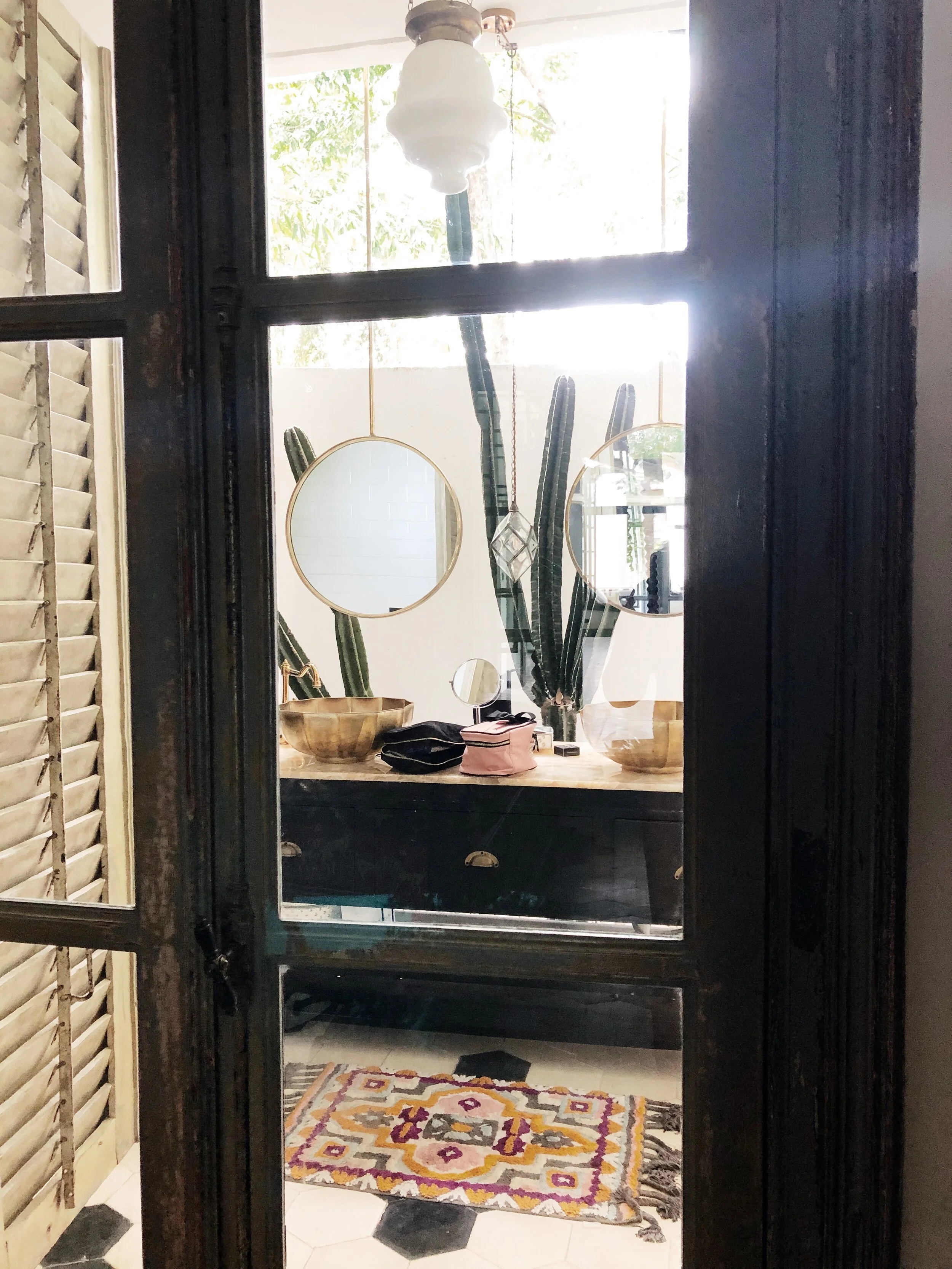 The french doors leading into the master bathroom came from a torn-down sugar factory in Java.