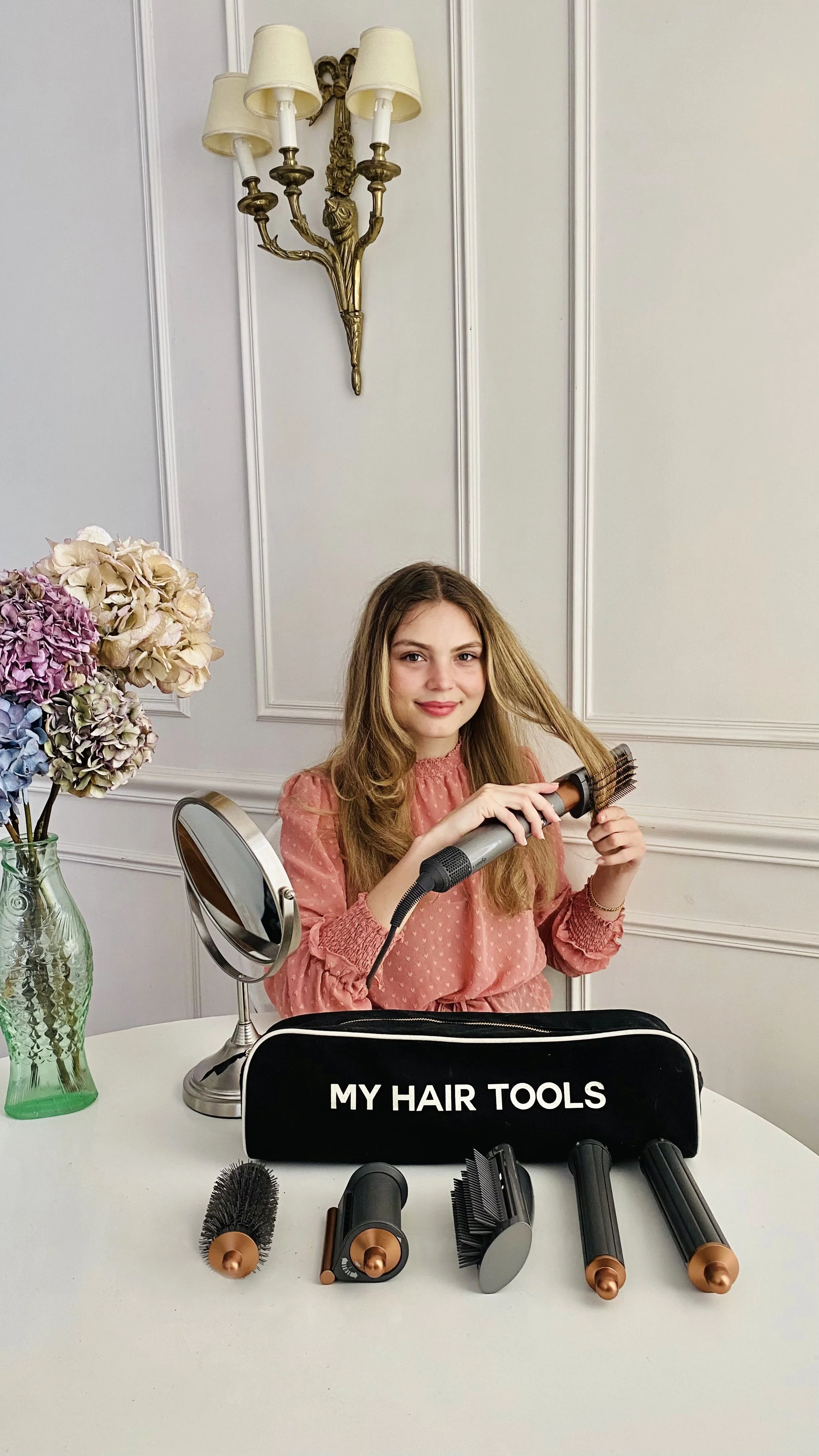 Hair tools organizer with hair dryer, brushes, and styling tools packed neatly for travel