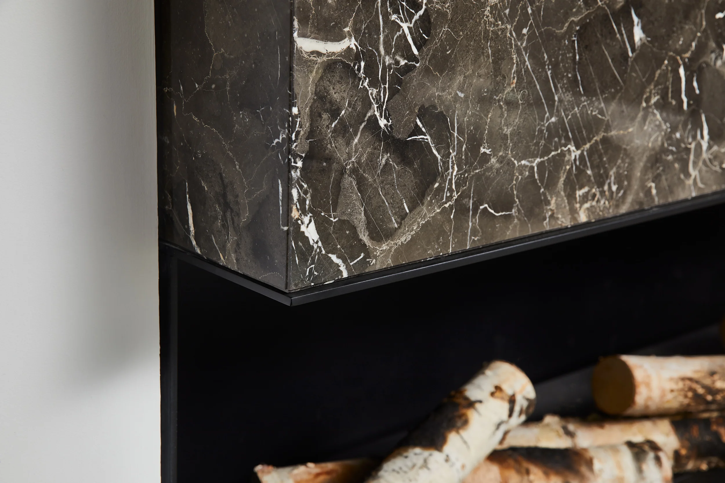 Minimalist marble fireplace detail in luxury minimalist apartment