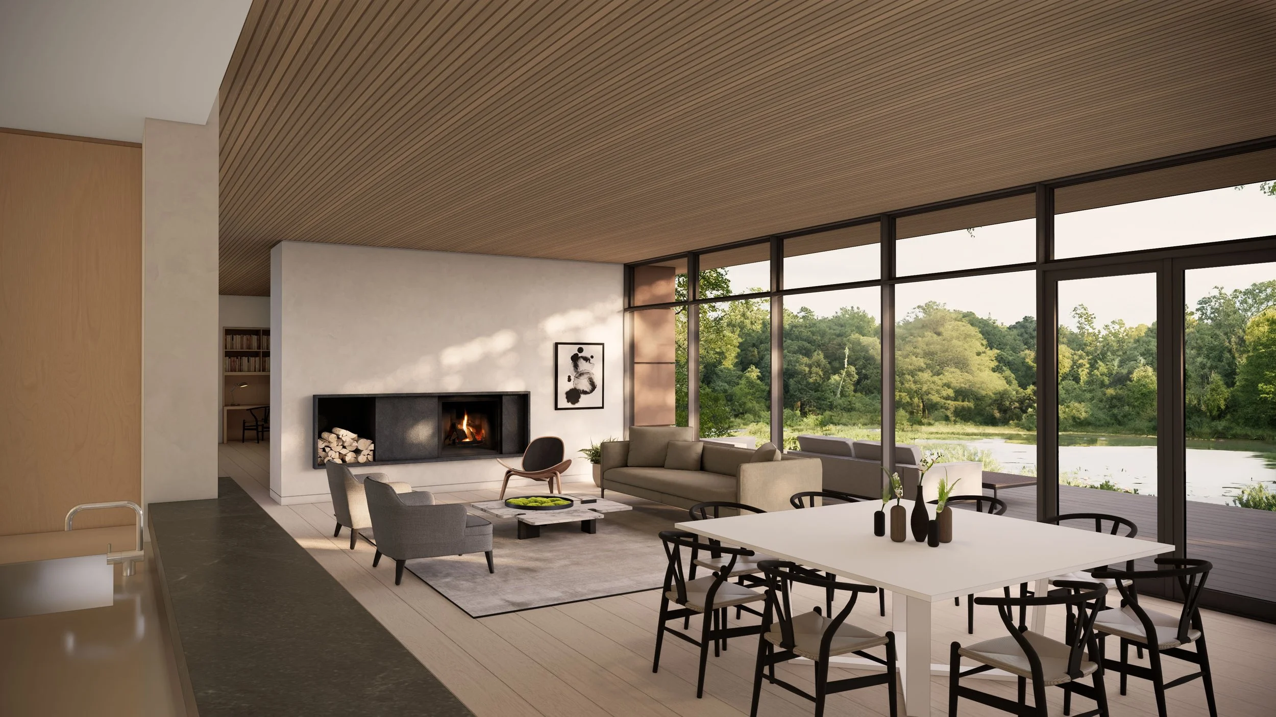 Modern living room with large windows overlooking a lake, fireplace, gray sofa, armchairs, and a white dining table with black chairs.