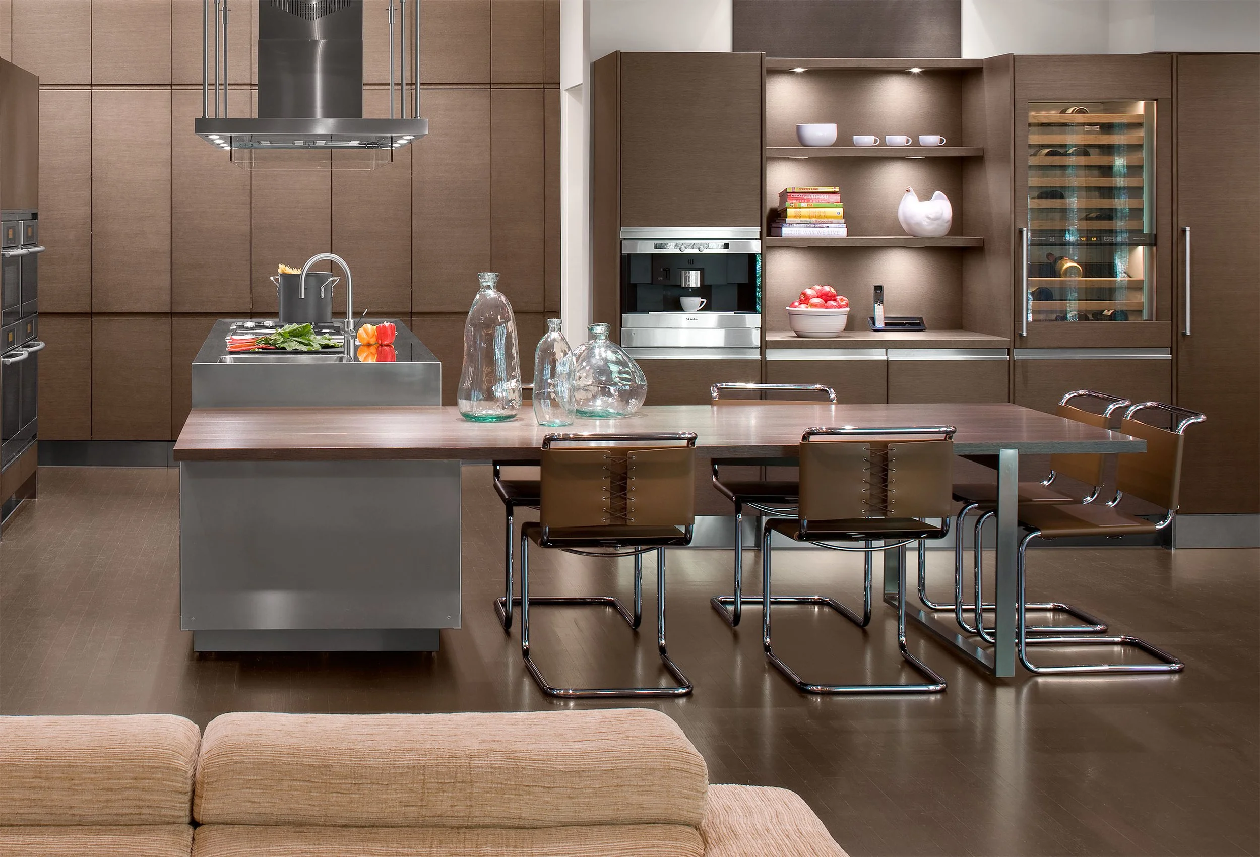 A modern kitchen island with a large built-in dining table