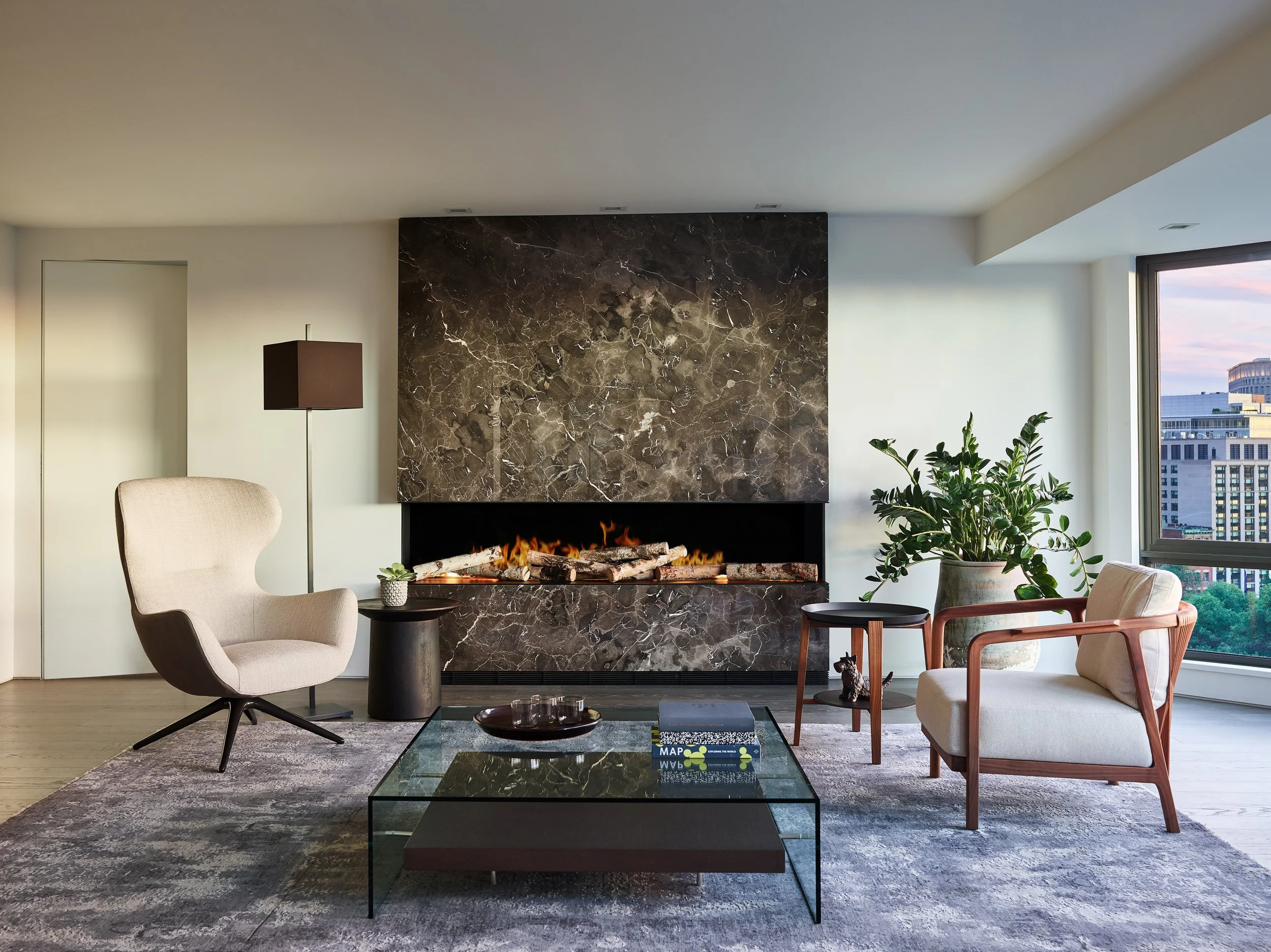 Minimalist condo renovation in Downtown Boston featuring a modern marble slab fireplace