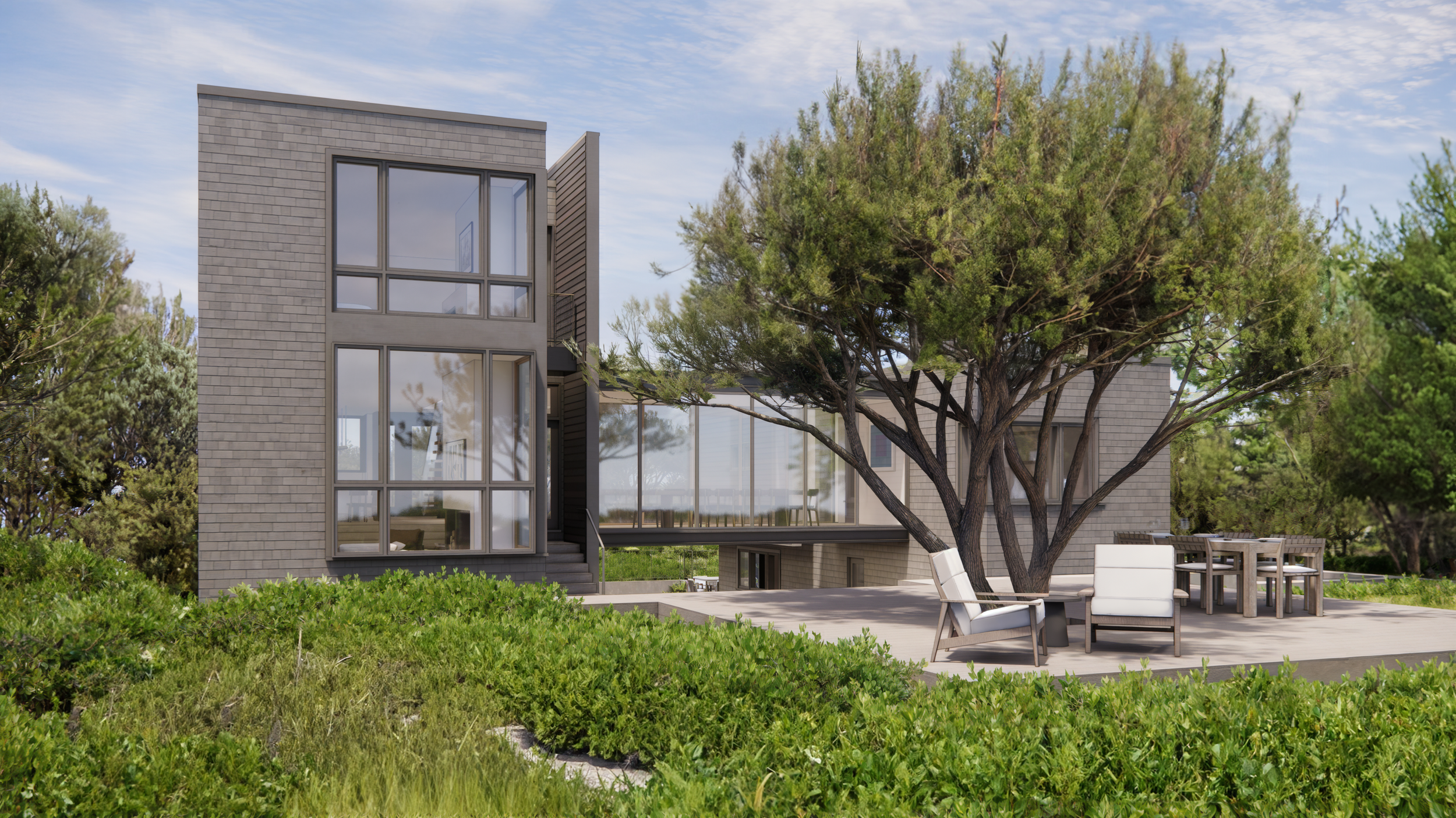 Modern beach house rear exterior featuring natural coastal landscaping.