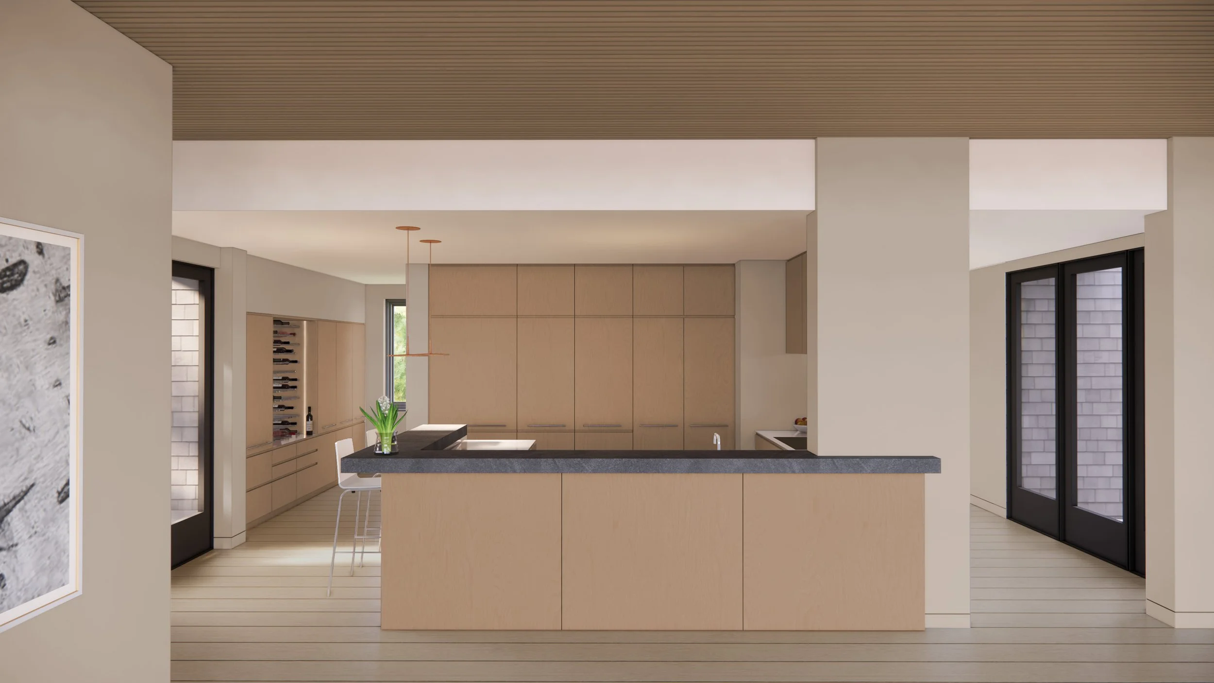 Modern kitchen with light wood cabinets, black countertop island, and large sliding glass doors.