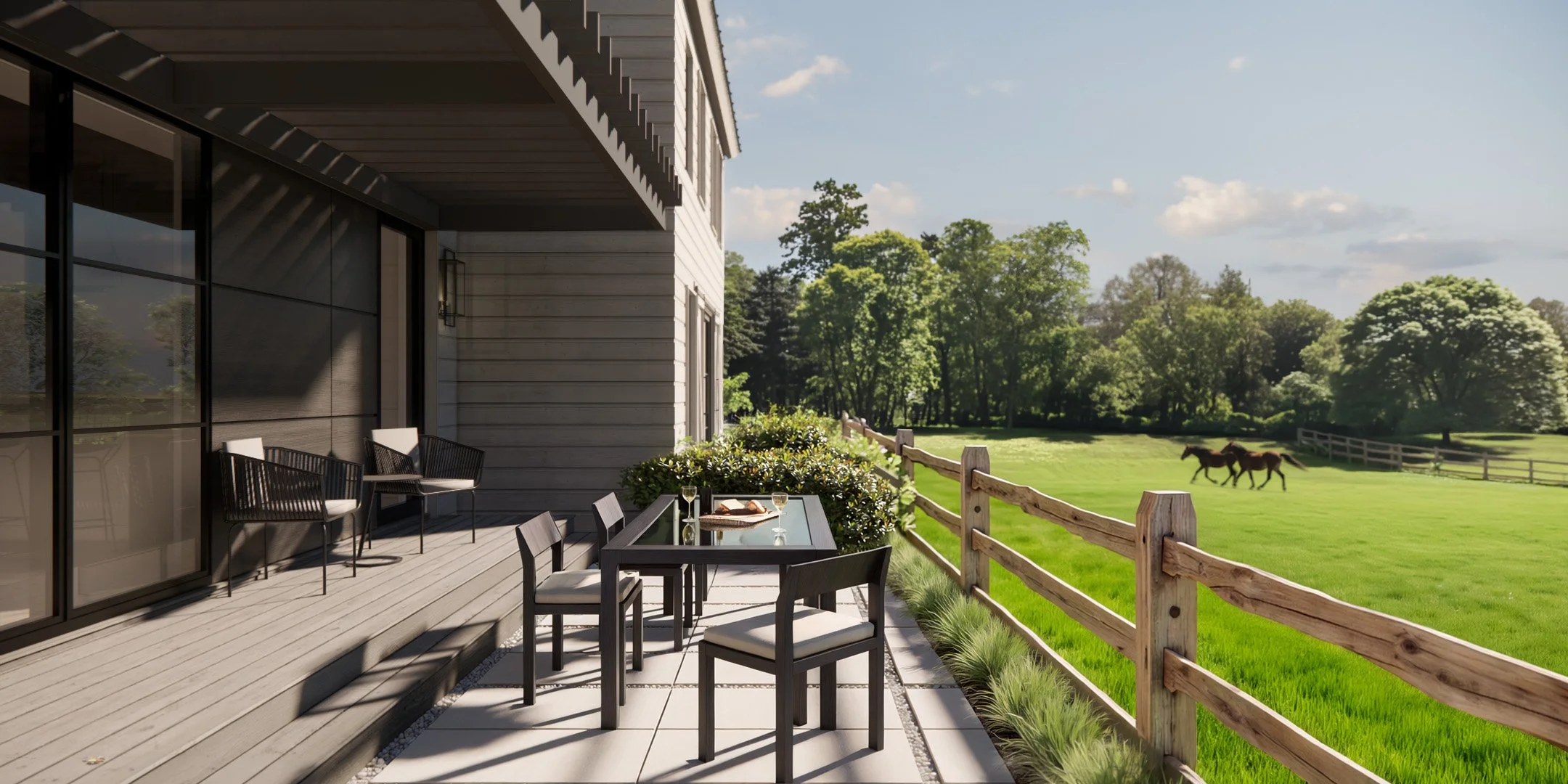 Rear deck and patio spaces in a modern farmhouse overlooking a horse pasture