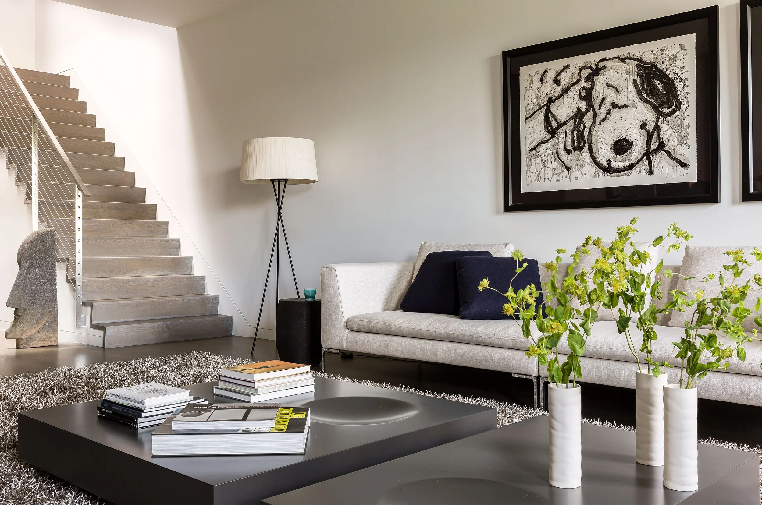 A minimalist townhouse renovation with sculptural dark wood coffee tables