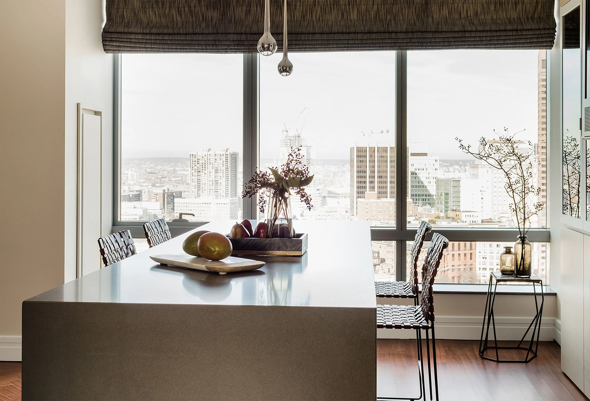A stone kitchen island with an integrated table overlooking downtown views