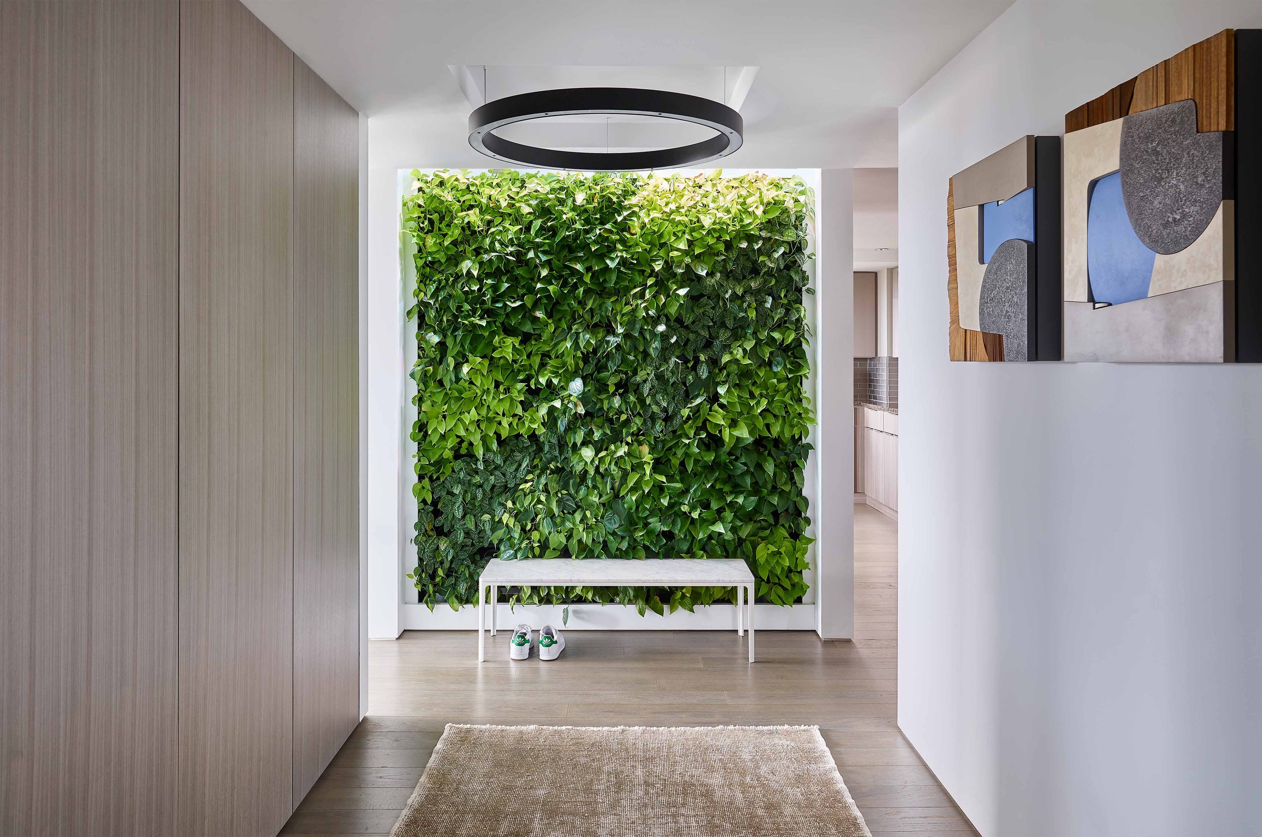 Condominium entry featuring modern wood paneling and a green wall