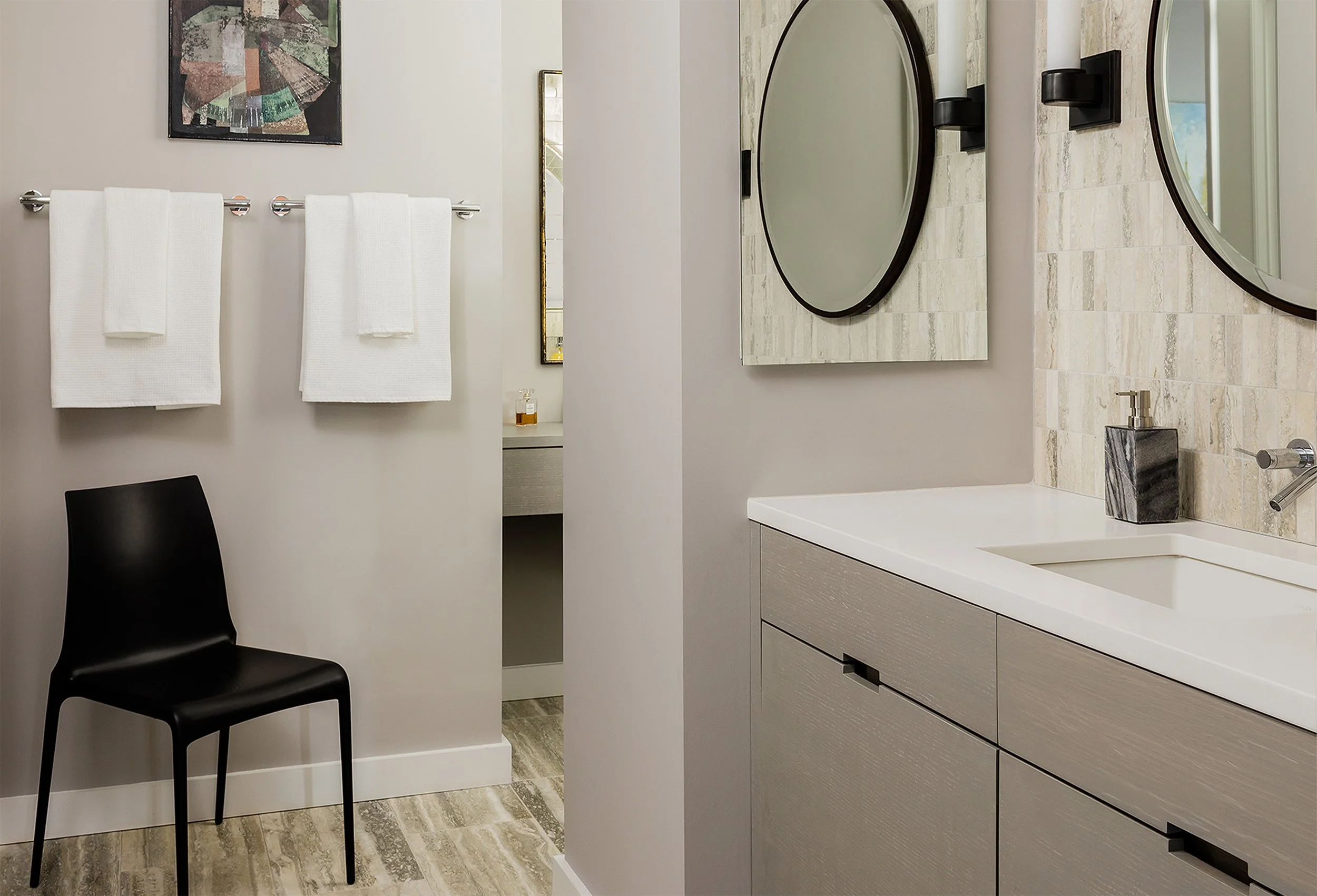 A modern bathroom vanity in warm tones in a renovated high-rise condominium
