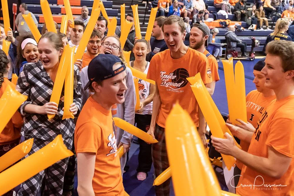 Photo taken by Craig Pessman of Spike Squad’s pre-game tradition of forming a tunnel to welcome the volleyball team.