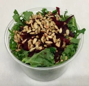 Kale with shredded beets and roasted sunflower seeds.