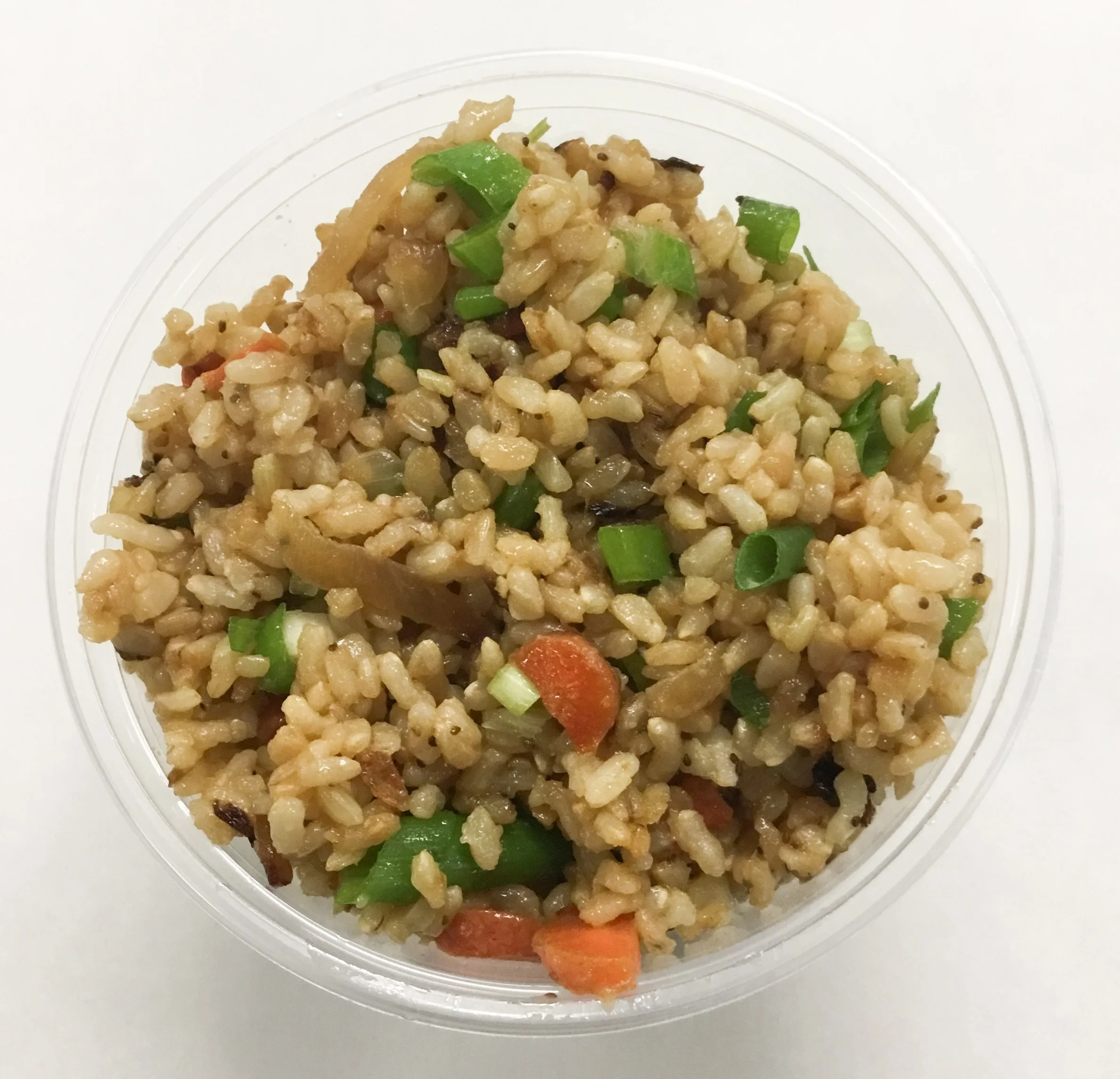 Stir fried brown rice wit onion, carrot and scallions.