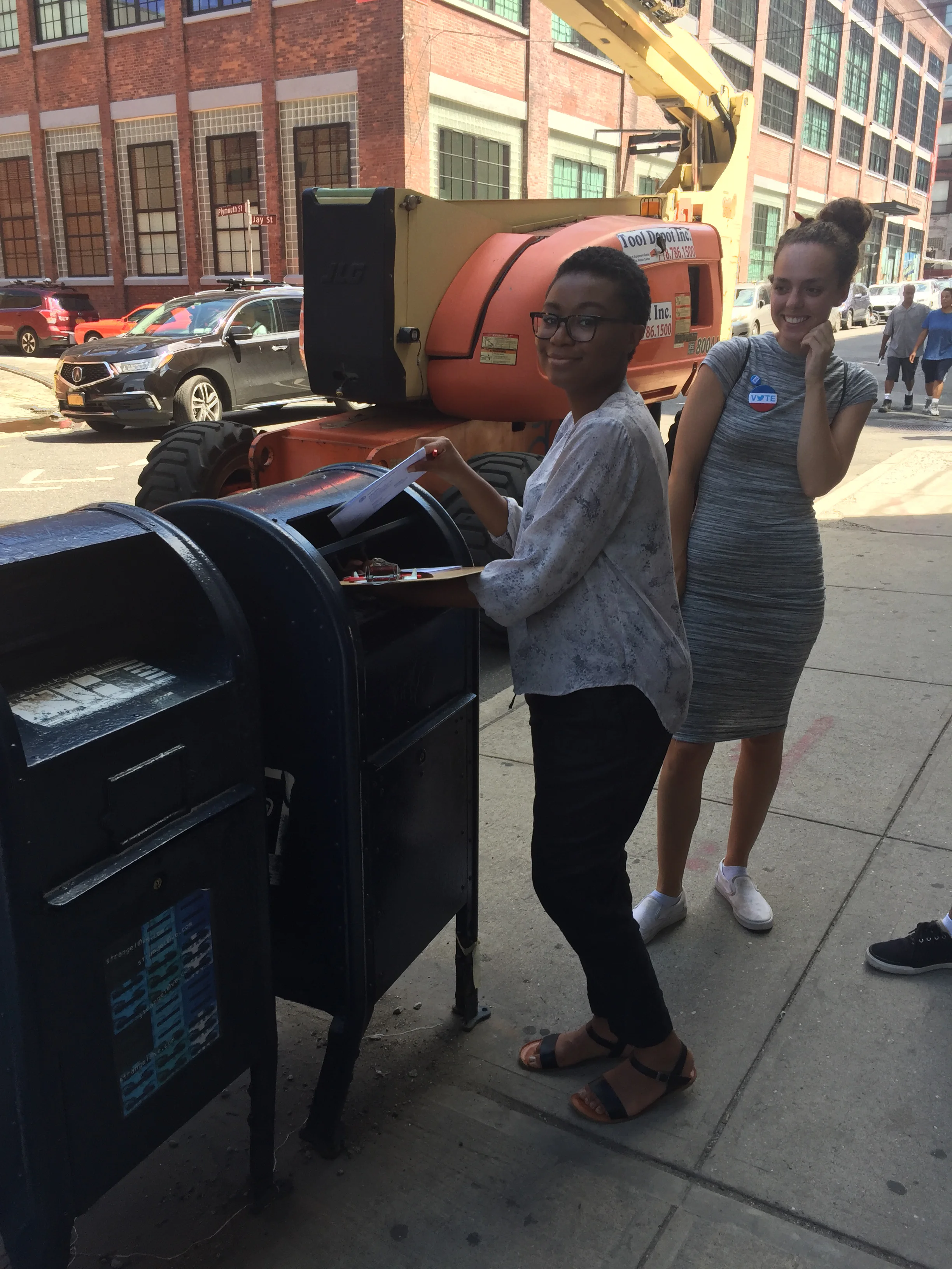 Thamara mails a completed voter registration form she helped a new citizen create.