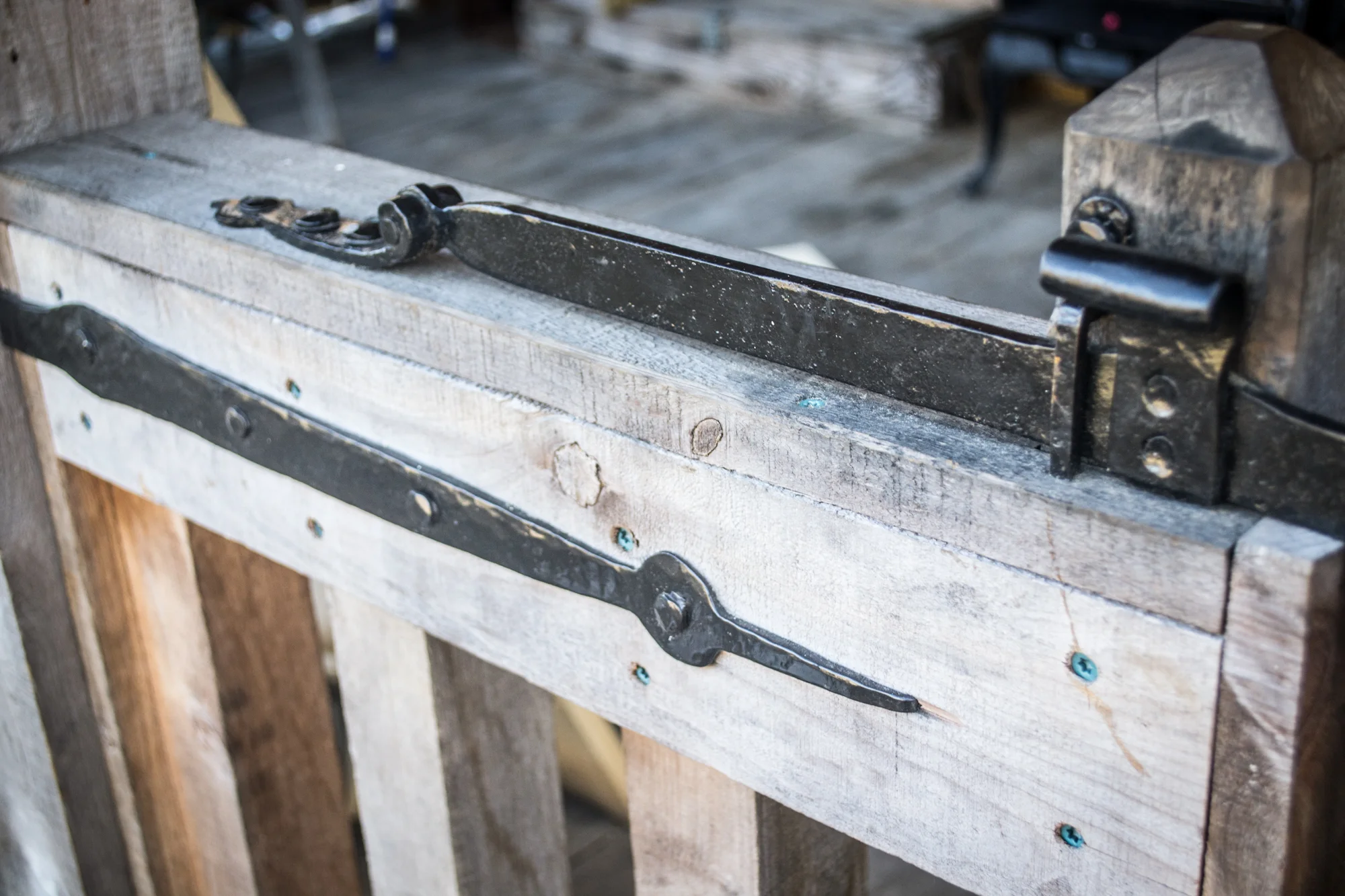The latch bar is heavy to help make the action of the latch faster, and mounted on the outside of the gates to help contain very small children.