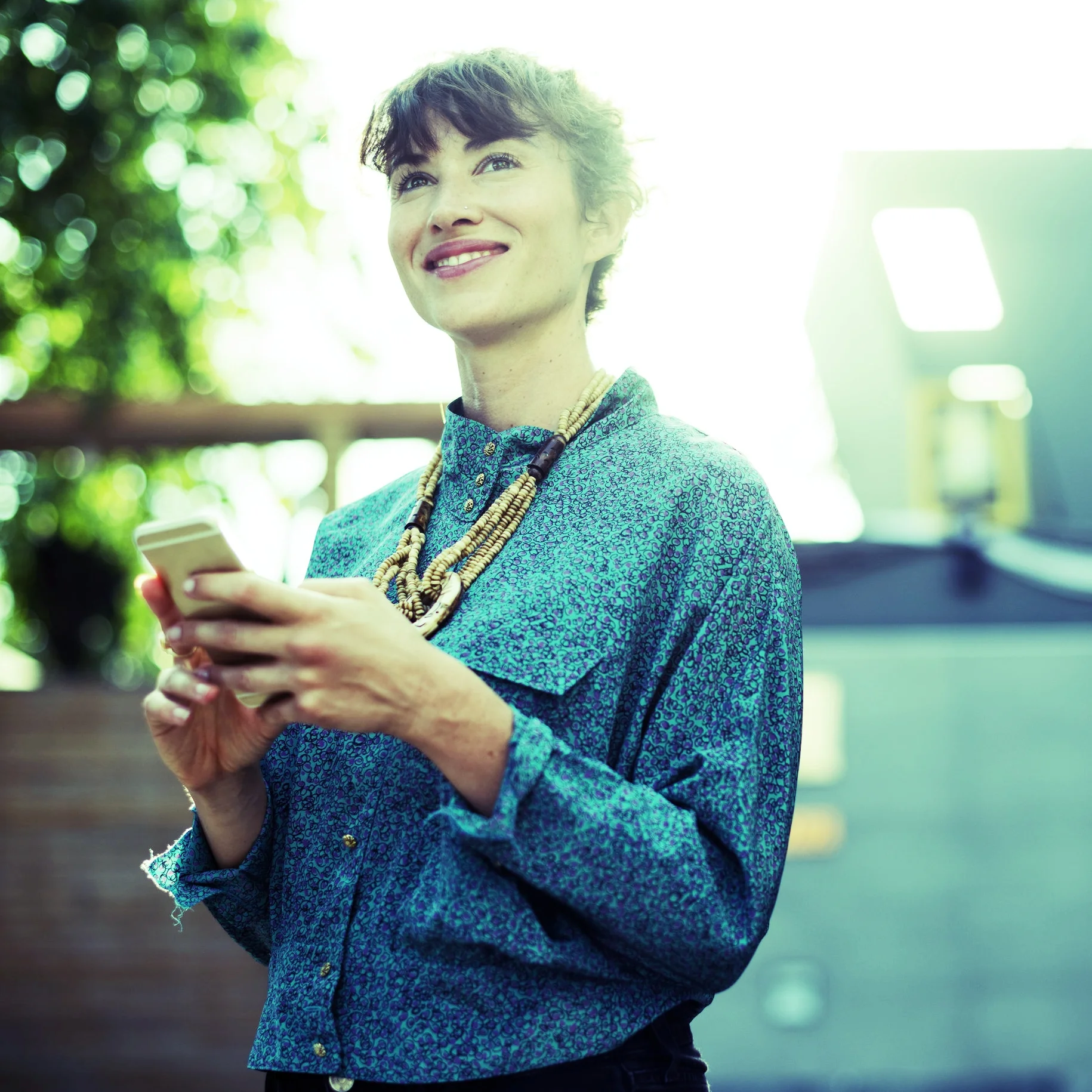woman in blue holding iphone for verification