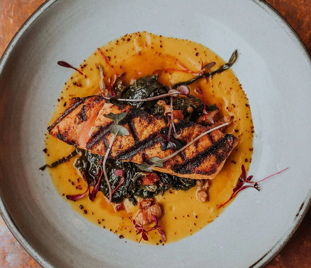 New to our autumn menu 🍂

𝗚𝗥𝗜𝗟𝗟𝗘𝗗 𝗪𝗜𝗟𝗗 𝗦𝗔𝗟𝗠𝗢𝗡
honeynut squash, aj&iacute; amarillo sofrito, smoked pork braised market greens, aj&iacute; mirasol

Bright, hearty, and full of fall flavor, this dish will warm you from the inside out.