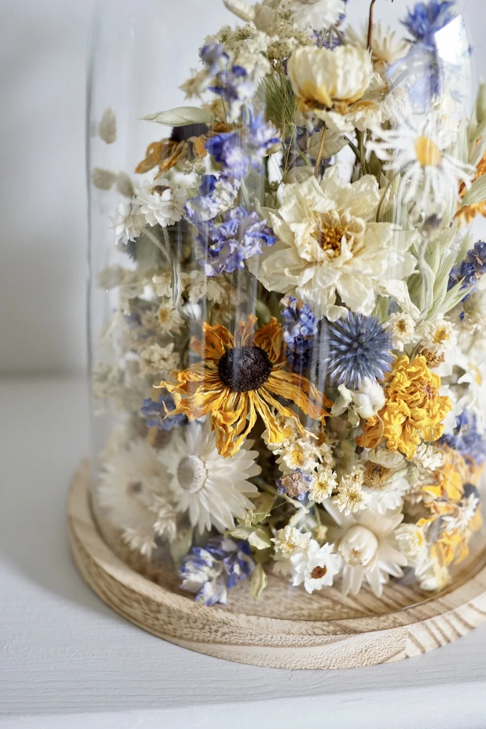 In a dried flower dome arrangement