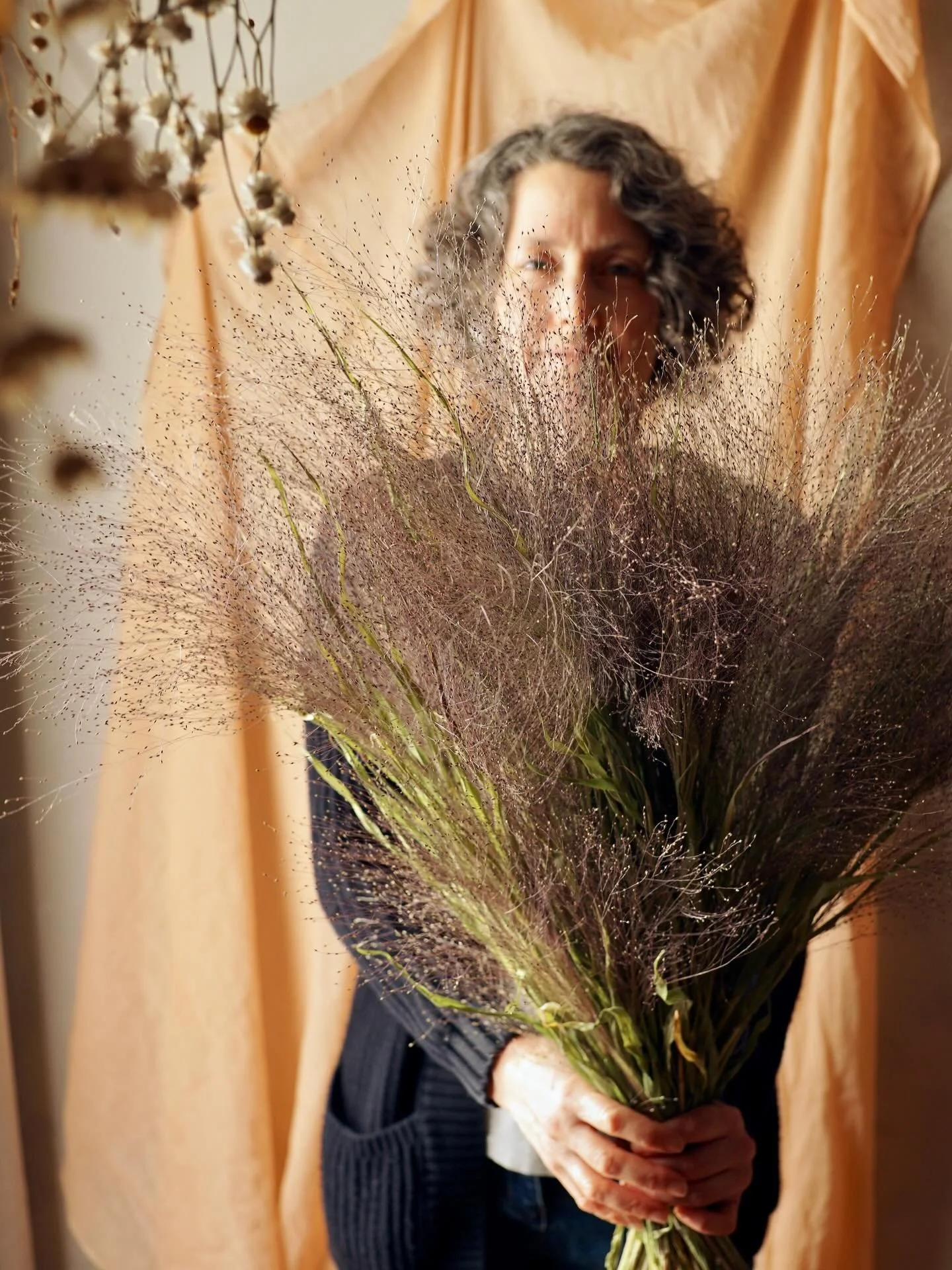 What should I do with all this dried Panicum sprinkles grass? 🌾

I dried loads of it last year with no plan for how to use it all! Pieces of it go into flower fairy skirts and I try to remember to add a stem or two to bouquets. Maybe more wreaths?

