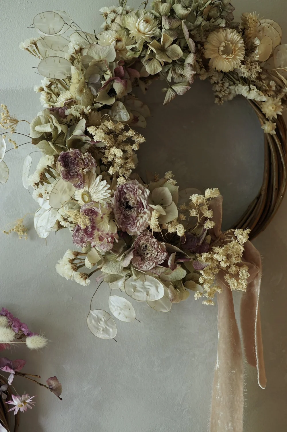 Dried flower wreath of pale purple, green and white