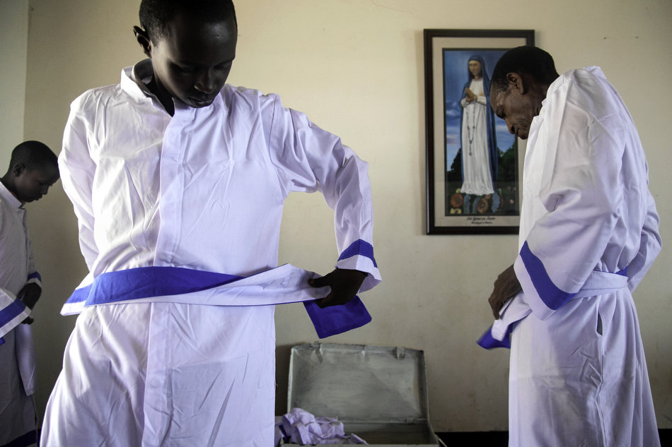  Choir members pull on their robes before mass at The Shrine of Our Lady of Sorrows in Kibeho, Rwanda. This is the only Marian shrine in Africa sanctioned by the Catholic Church.  