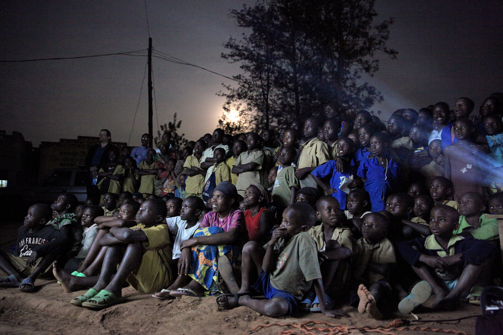  People watch a screening of "Rooster Says," an original animated film by Africa Digital Media Academy, and "Open Heart," a documentary by Cori Stern, in Bugesera, Rwanda.  