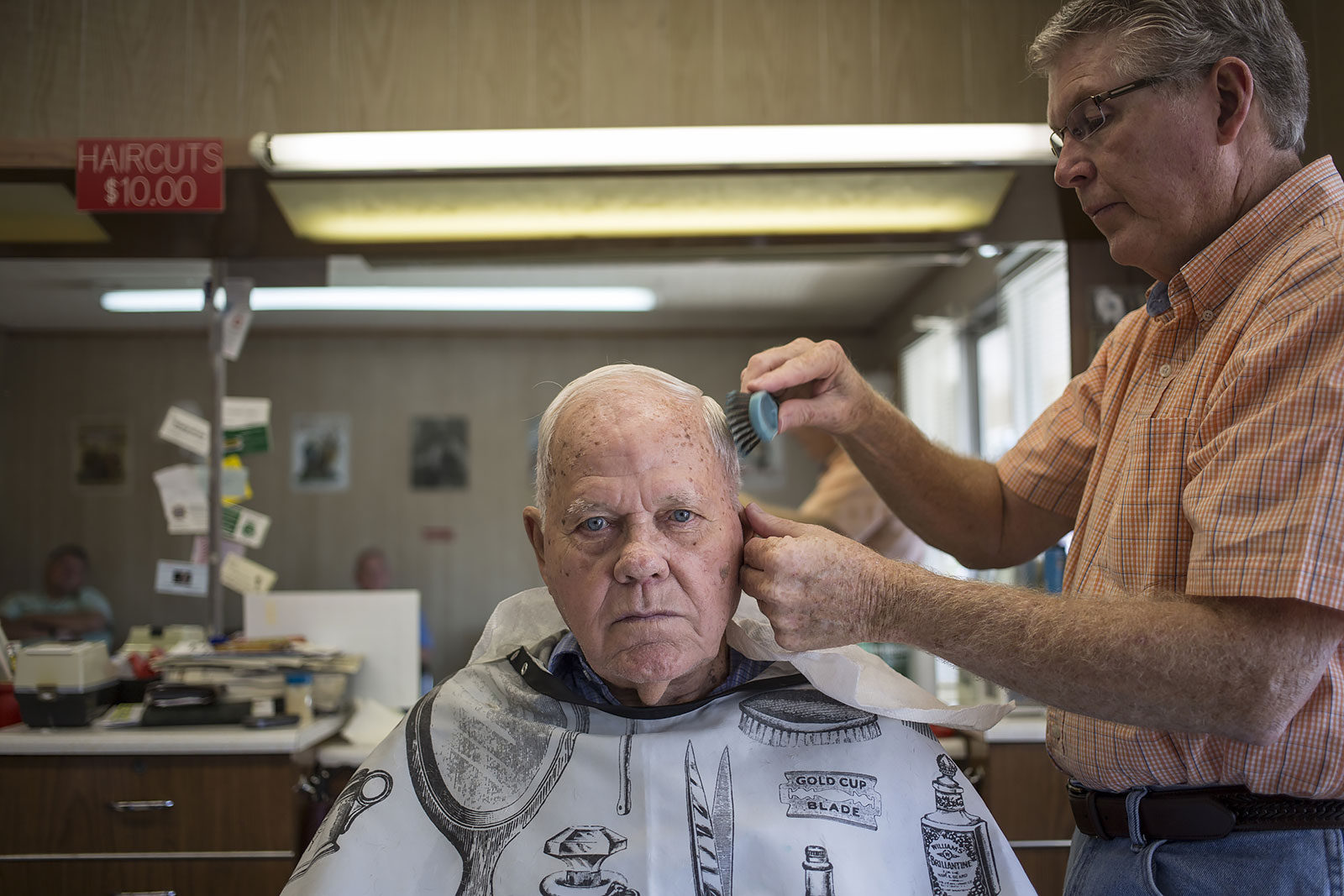 My pap-paw Pete Armes, 91, gets a haircut from lifetime Franklin, North Carolina resident Ronnie Dills. Dills has been cutting hair for 45 years, 43 in this location and generations of residents have pulled up a seat for a trim.