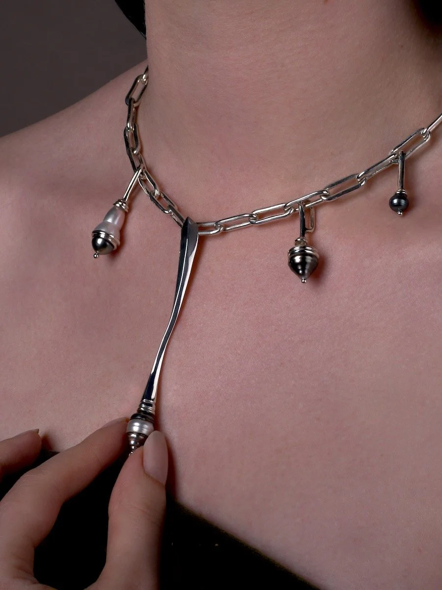 Model spinning the Spindrift statement pearl necklace, made from sterling silver, mixed pearls and diamond by Charlotte Garnett