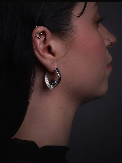 model wears designer pearl Cove hoop earrings in silver and dark pearl by designer Charlotte Garnett