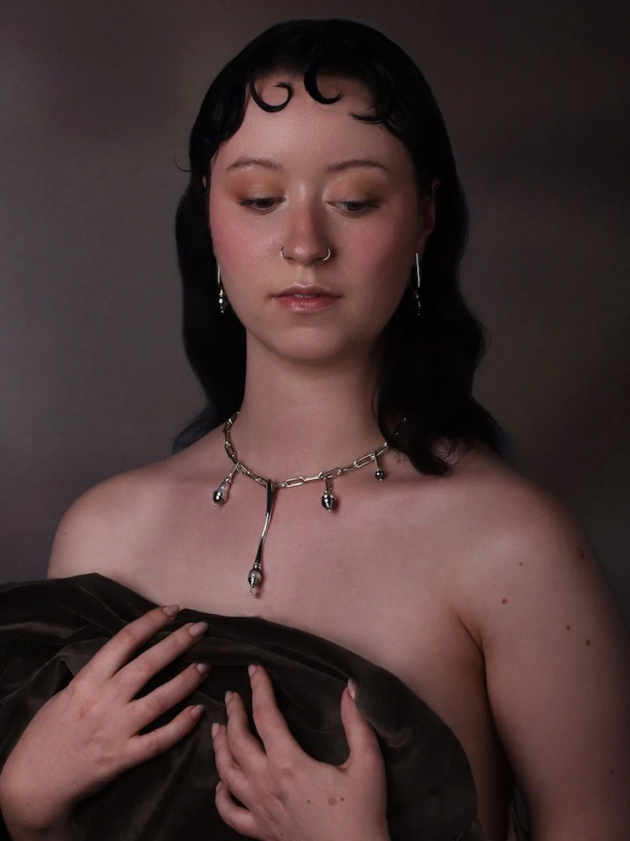 model wears the Charlotte Garnett Spindrift statement Pearl Necklace and Eddy Pearl Drop earrings, made from sterling silver, mixed pearls and diamond.