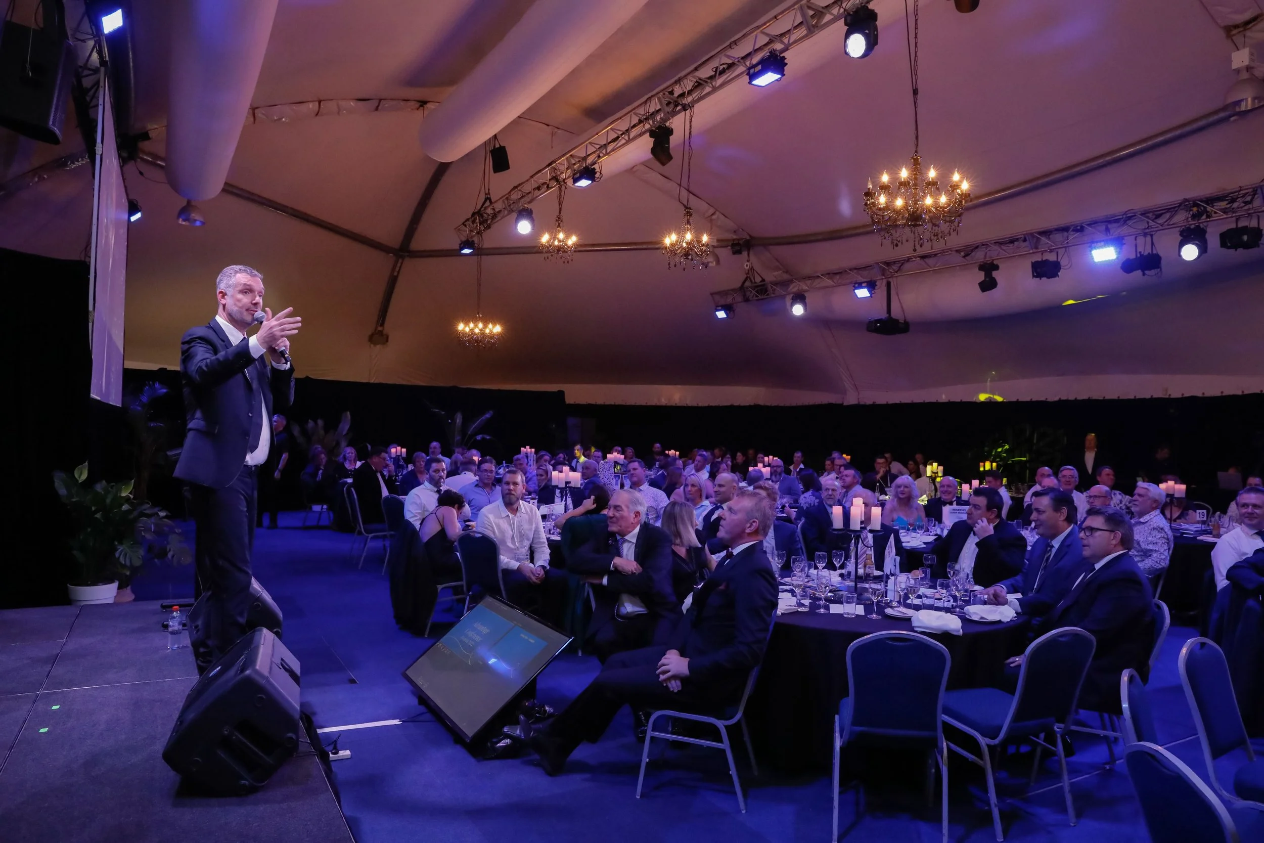 Corporate MC Andrew Gill engaging with an audience at an event in Port Douglas, Queensland.