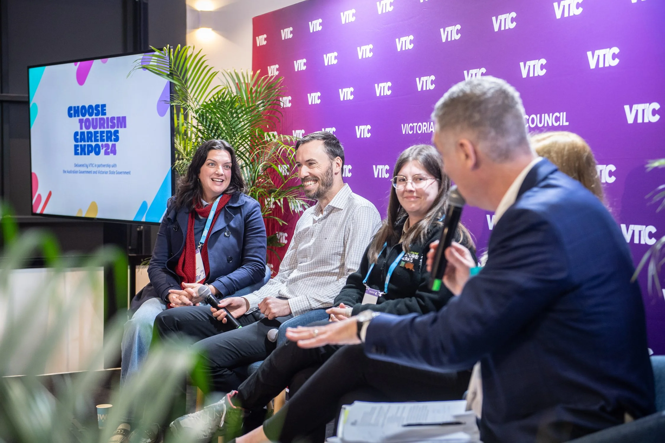 Andrew Gill moderating a panel discussion at a corporate event in Melbourne.