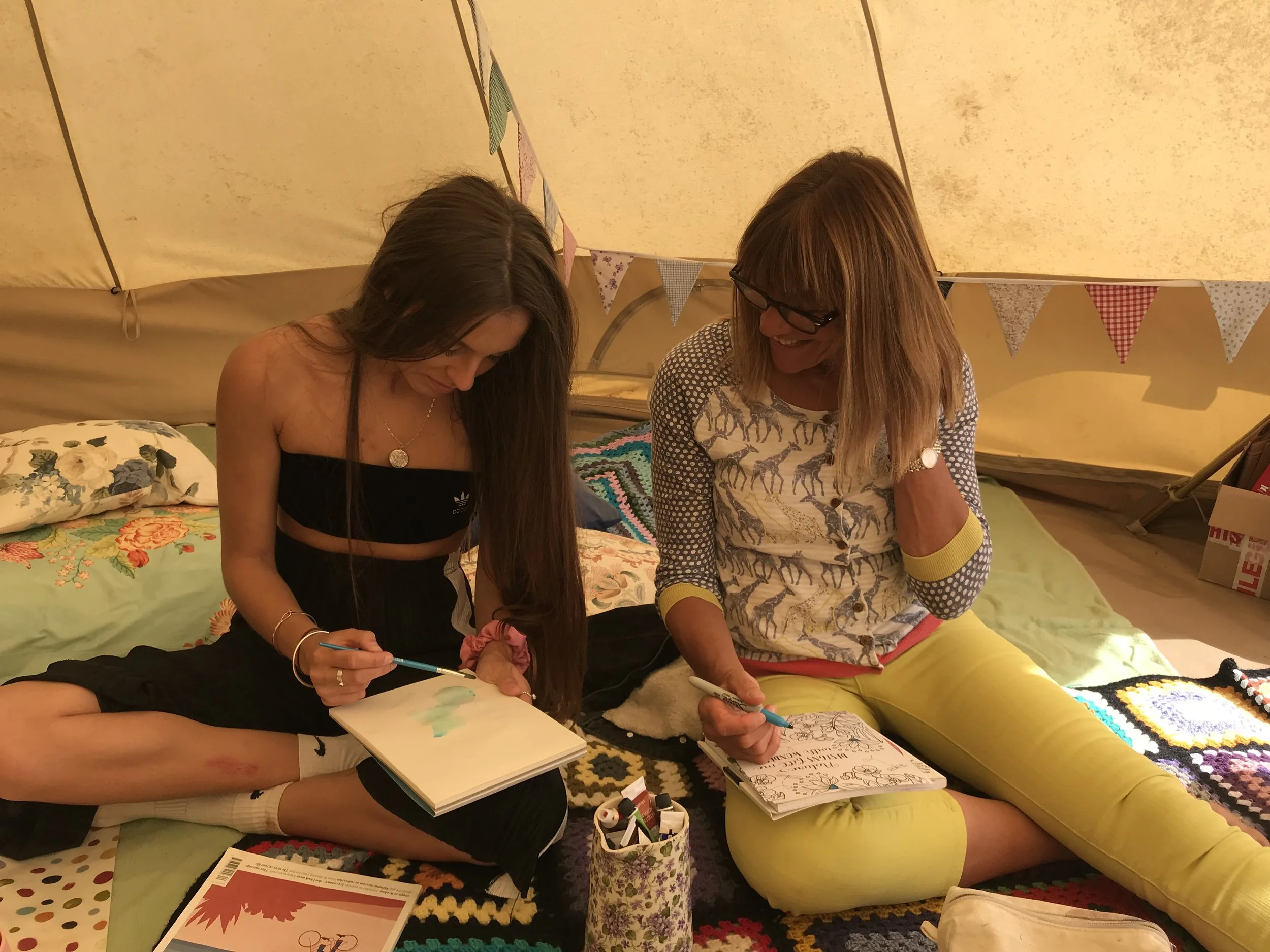 Mother and daughter enjoying some artistic relaxation together in the Well Tent.