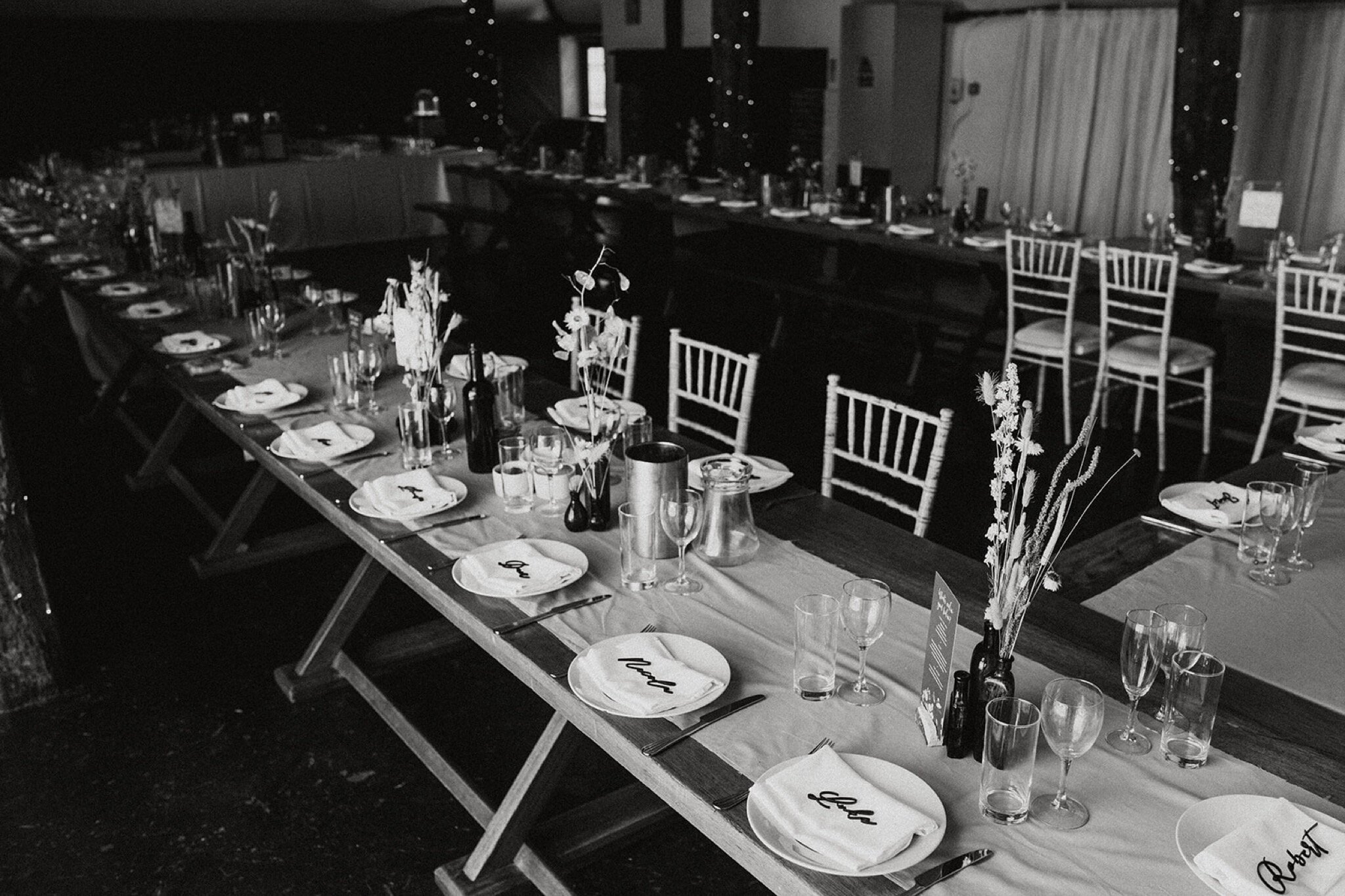 29_V+D Wedding-430_black and white photo of wedding breakfast table and place names with dried flowers%0A.jpg