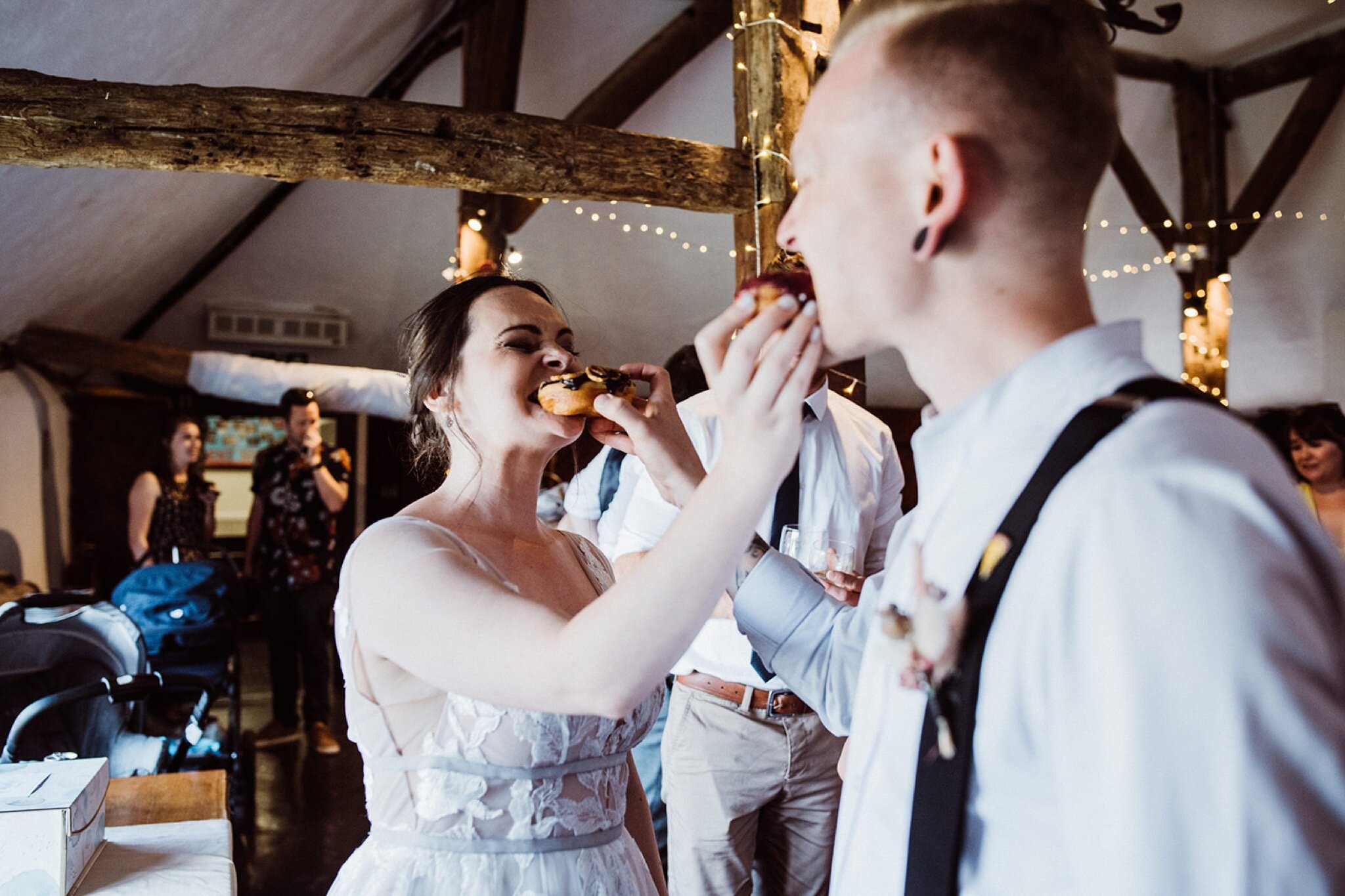 39_V+D Wedding-634_bride and groom feeding each other donuts%0A.jpg