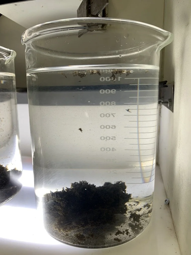 Fracking wastewater after Watermen chemical treatment with visibly clearer water and separated solids