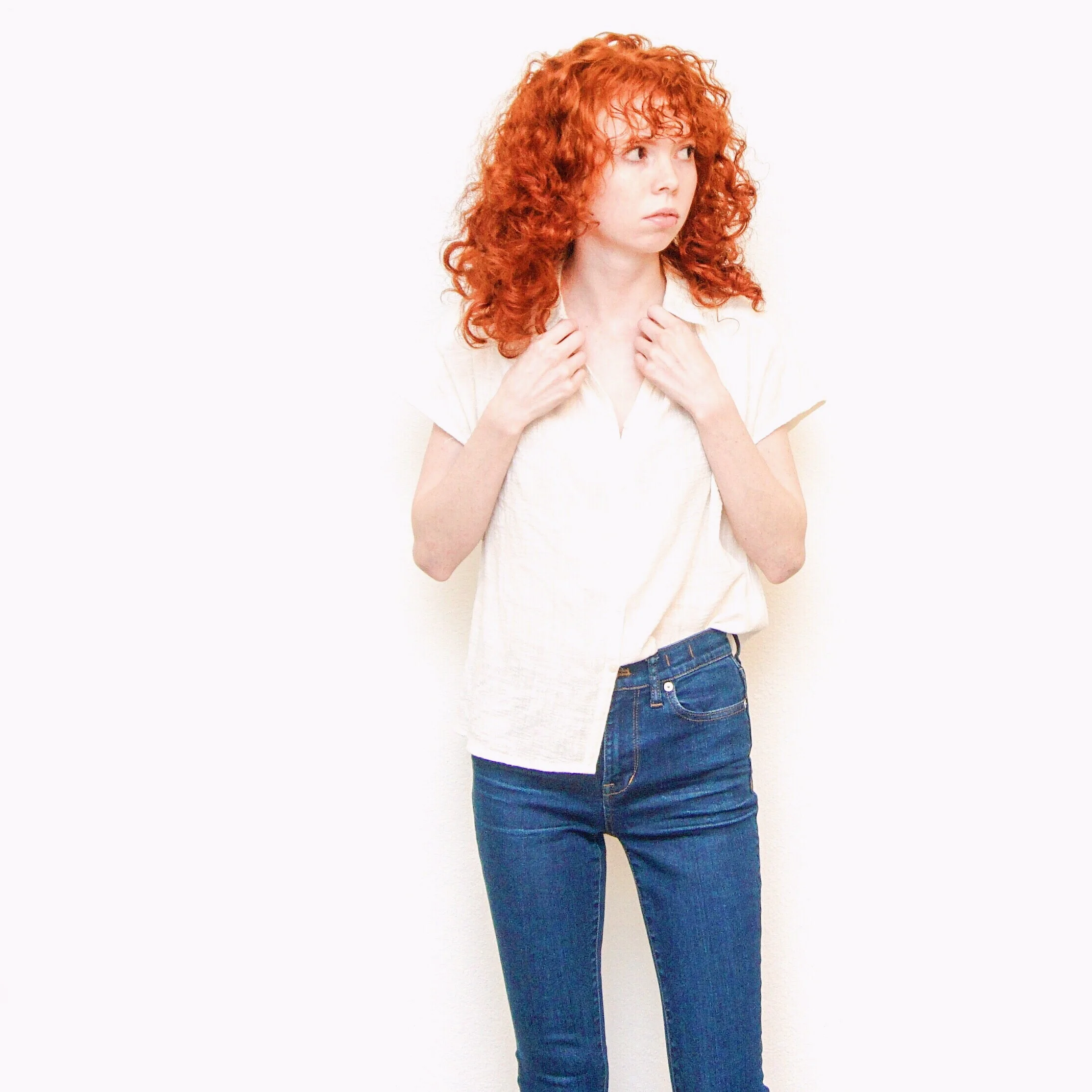 girl-in-white-blouse-and-dark-jeans