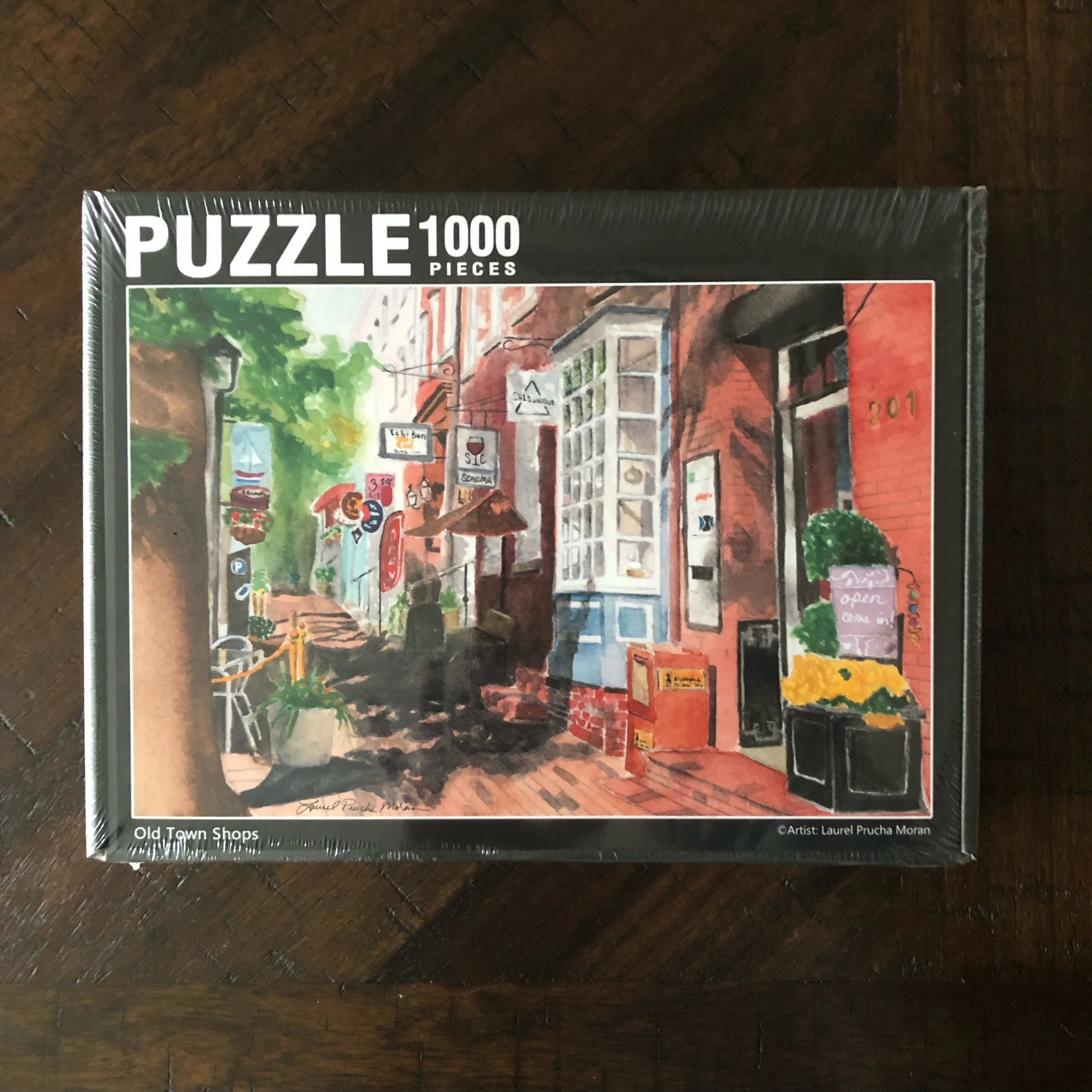 1000-piece puzzle of Old Town Shops by Alexandria artist Laurel Prucha Moran