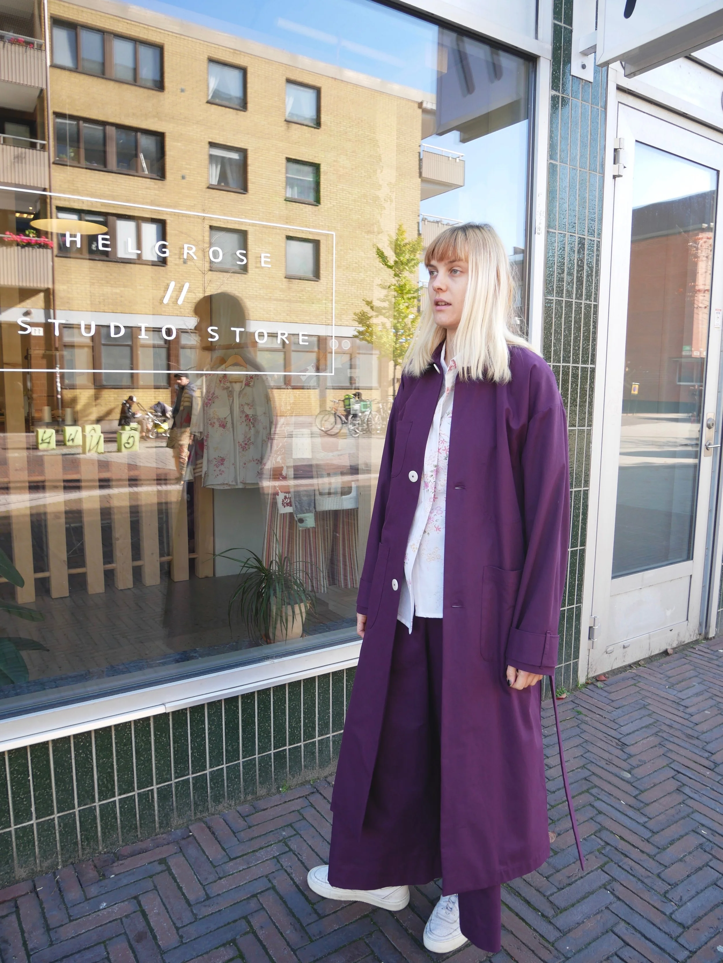 Unisex royal purple trench coat made from GOTS certified organic cotton with corozo buttons. Made in Malmö, Sweden.