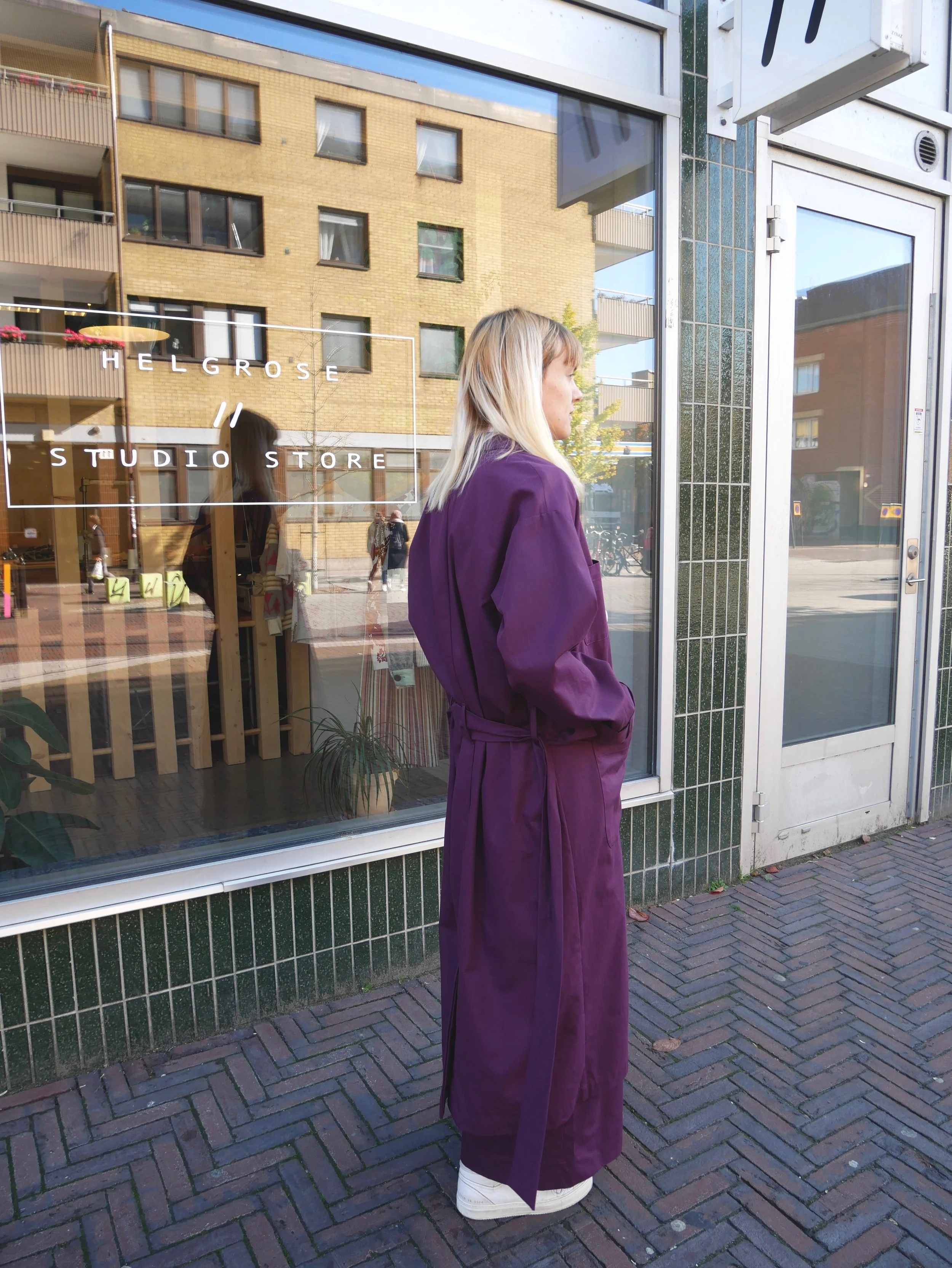 Unisex royal purple trench coat made from GOTS certified organic cotton with corozo buttons. Made in Malmö, Sweden.