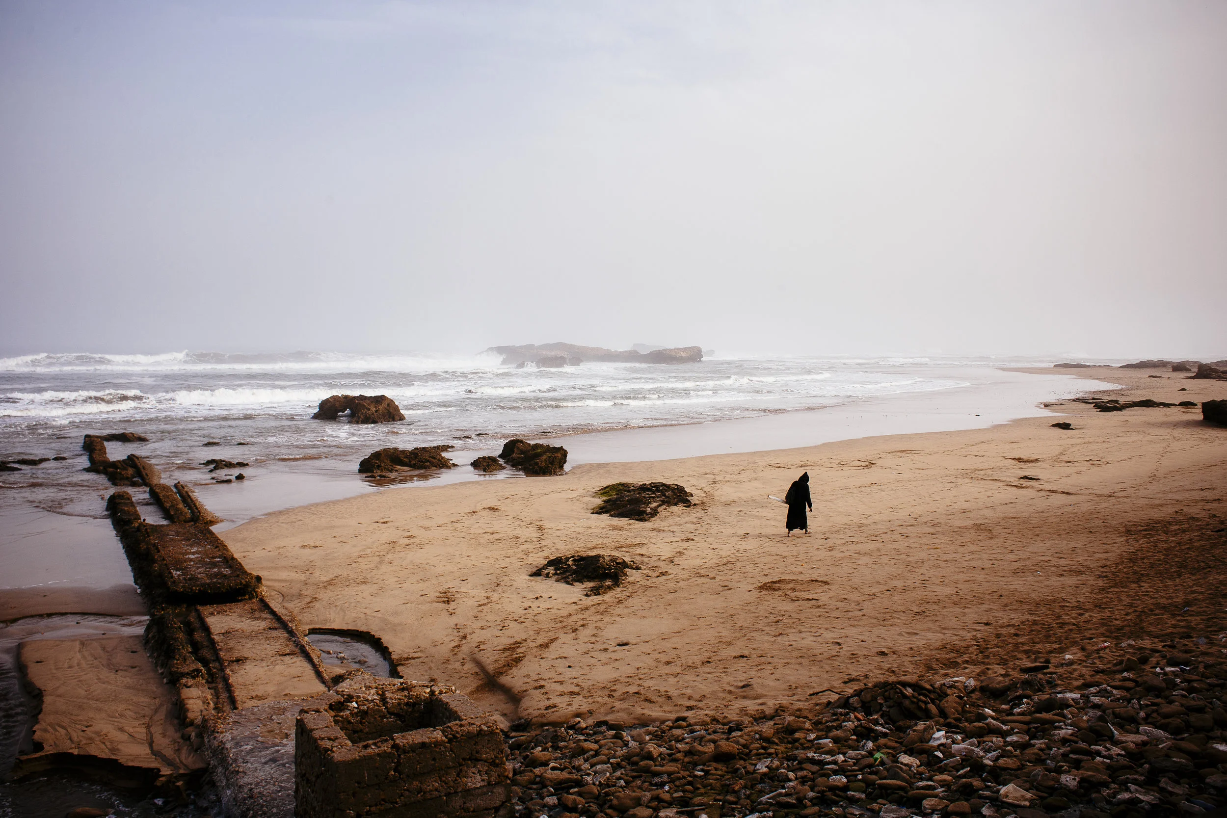 A man walks along a beach in Essaouira, Morocco, Wednesday, March 14, 2007.
